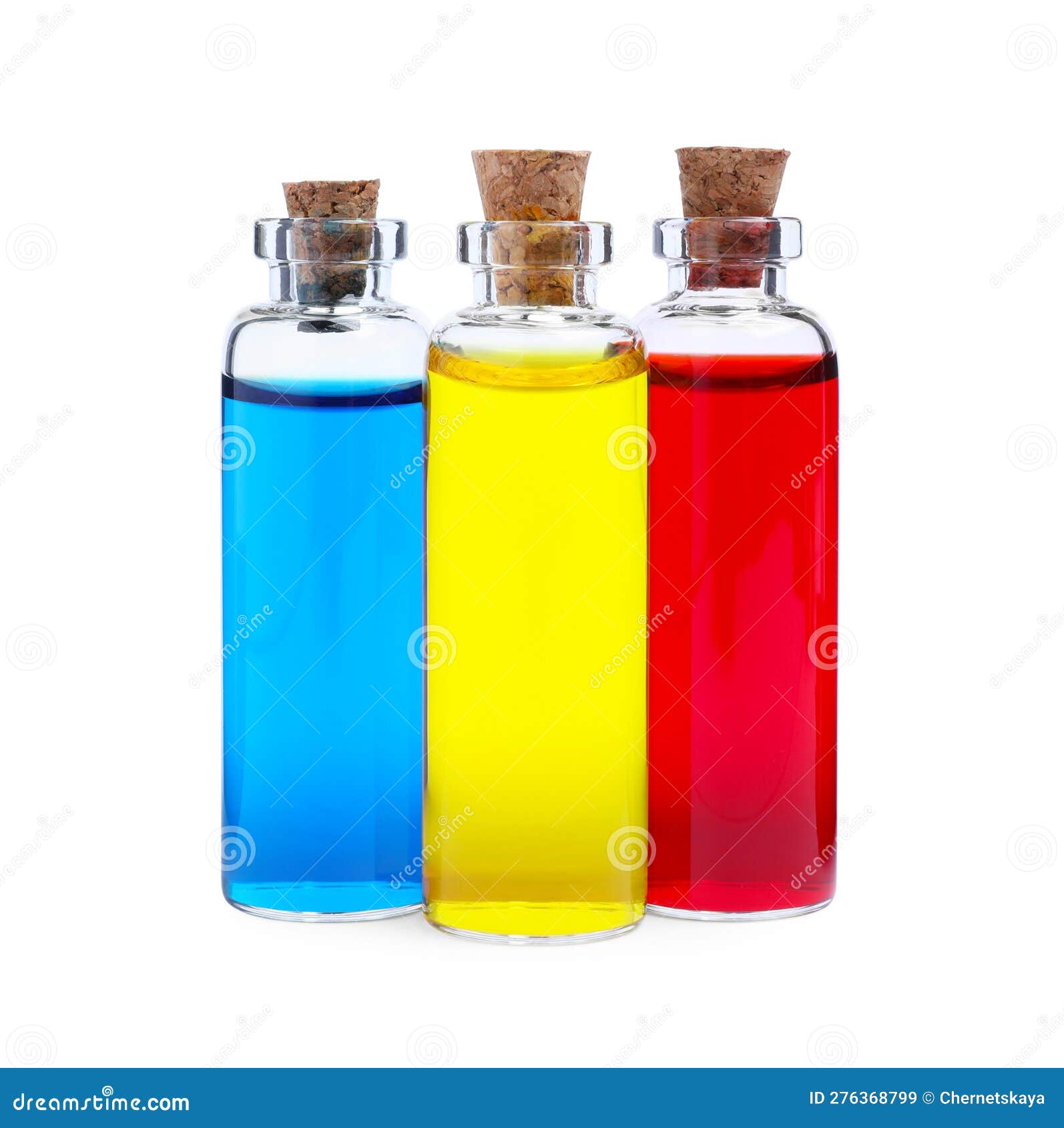 Glass Bottles with Different Food Coloring on White Background Stock