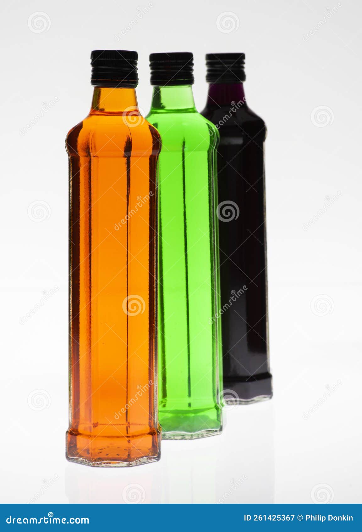 Glass Bottles Filled with Food Colouring on a White Background Stock