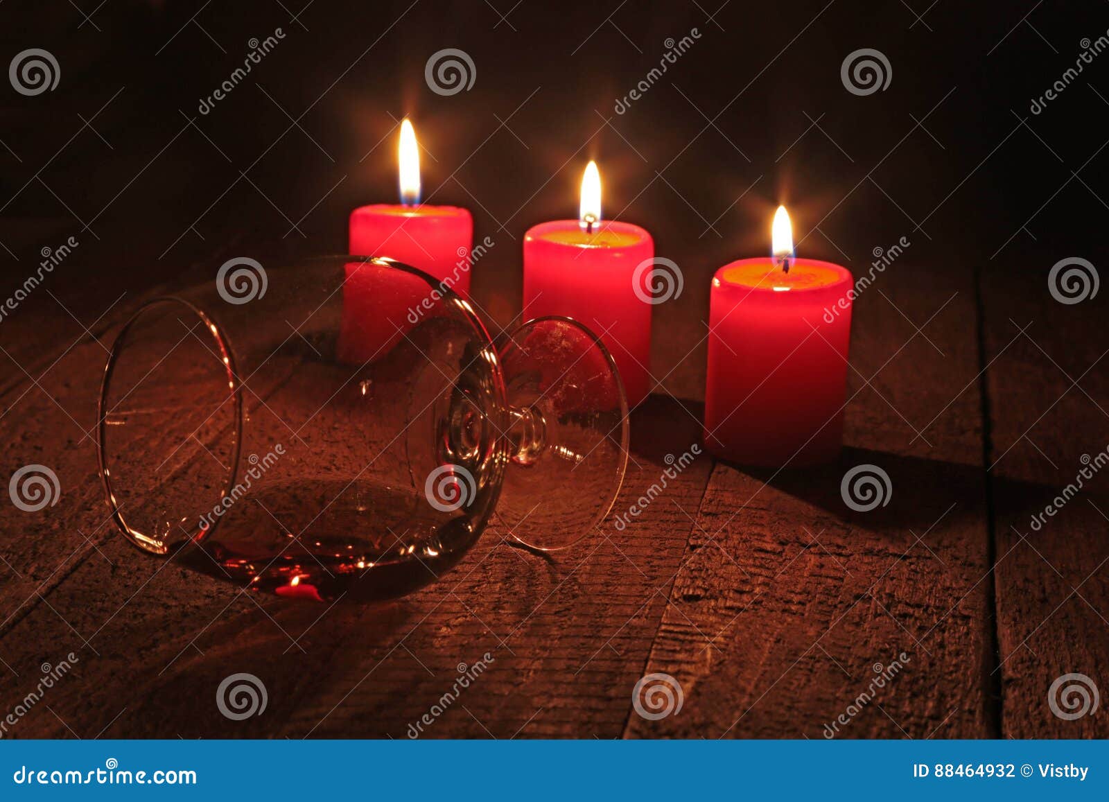 Glass of Brandy or Cognac and Candle on the Wooden Table. Celebration