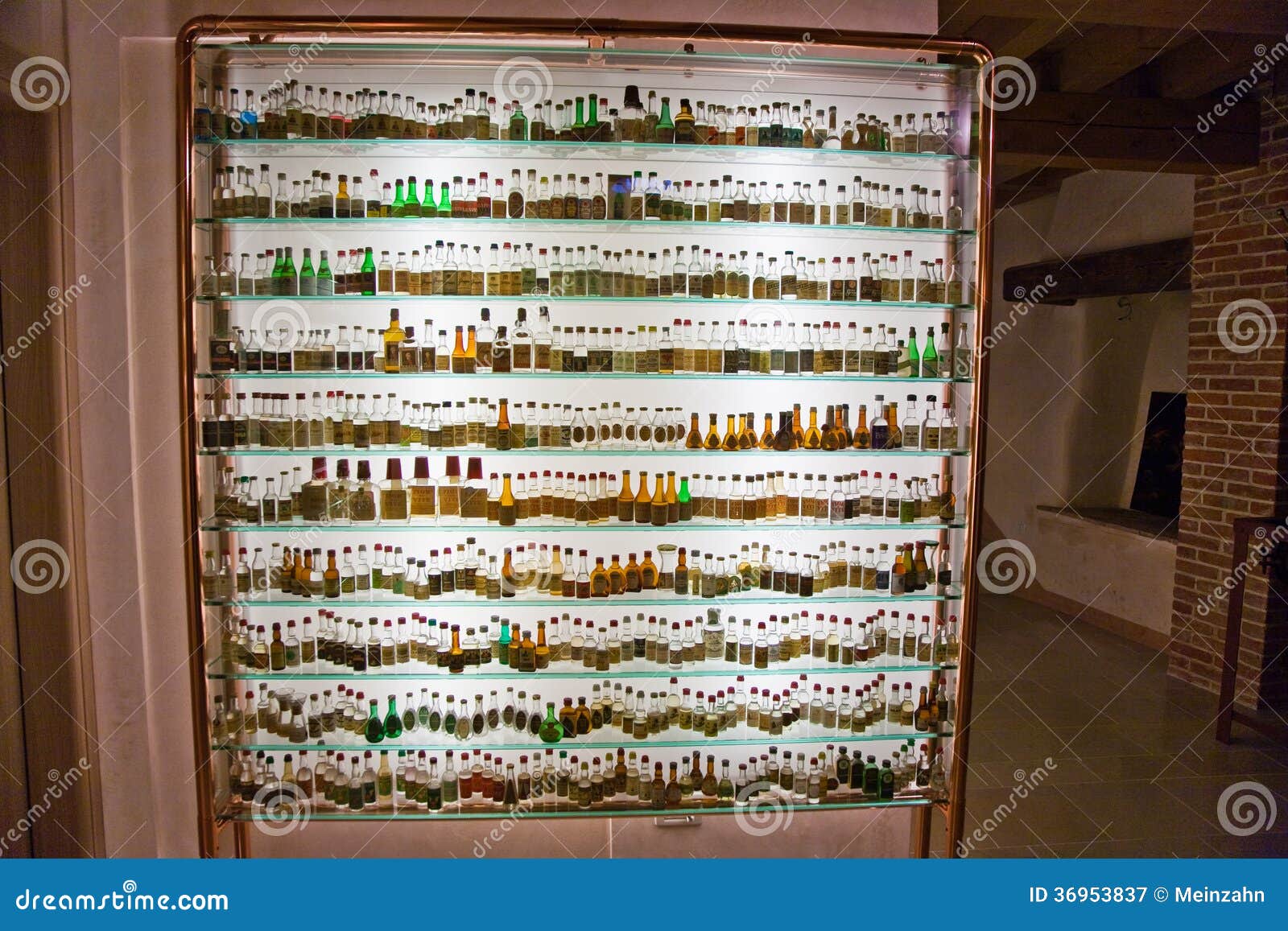 Glass Cabinet With Historic Bottles Of Grappa In A Museum In