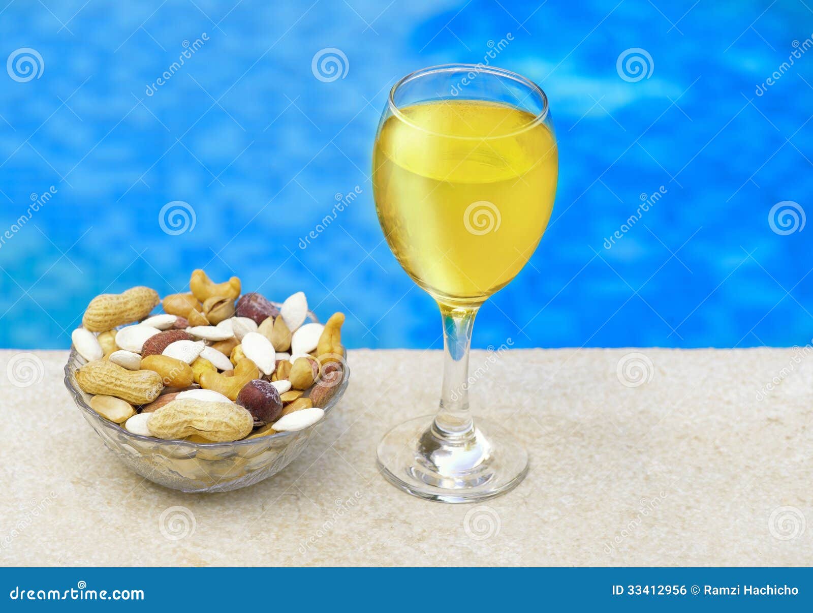 Glass of Champagne & Nuts beside the Pool Stock Photo Image of