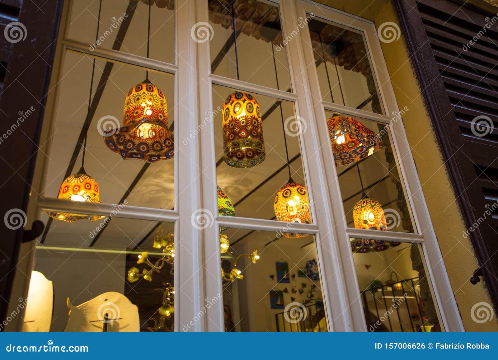 Glass Chandeliers Decorated with Lights Lit through the Window Stock