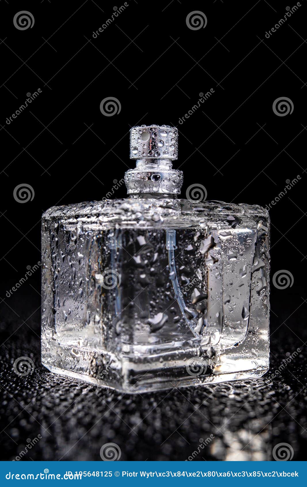 Glass Container with Perfume Covered with Drops of Water. a Wet Bottle