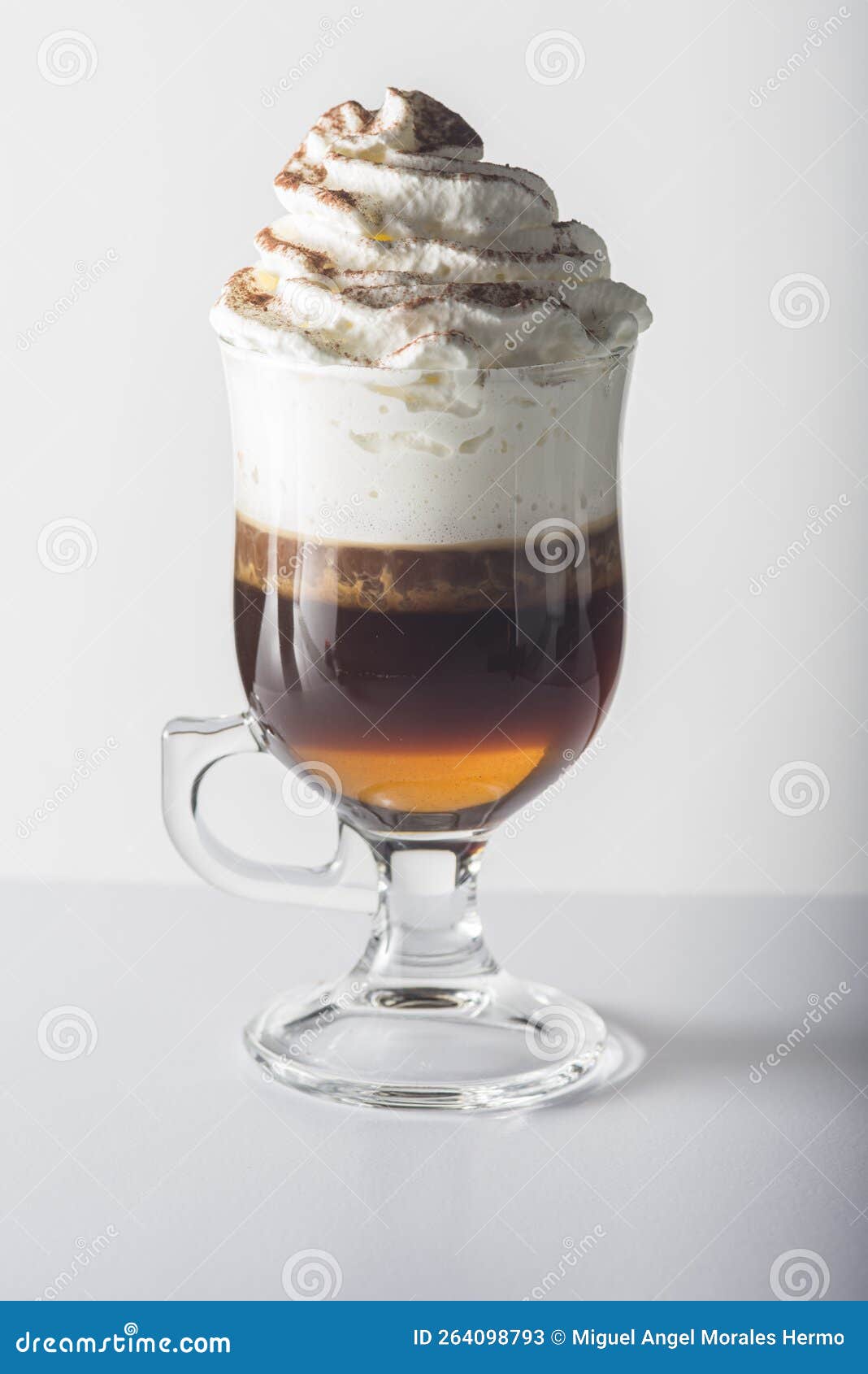glass cup with handle containing coffee.