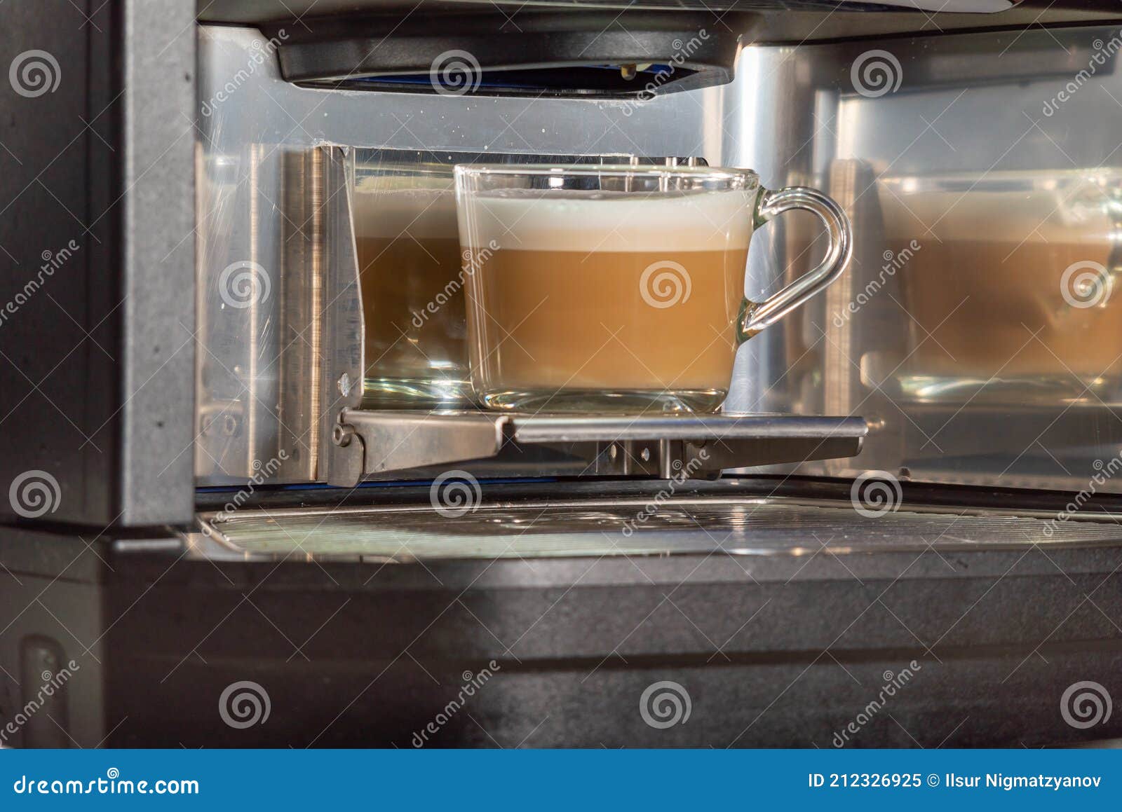 Glass Cup with Prepared Aromatic Coffee Latte in a Coffee Machine in a