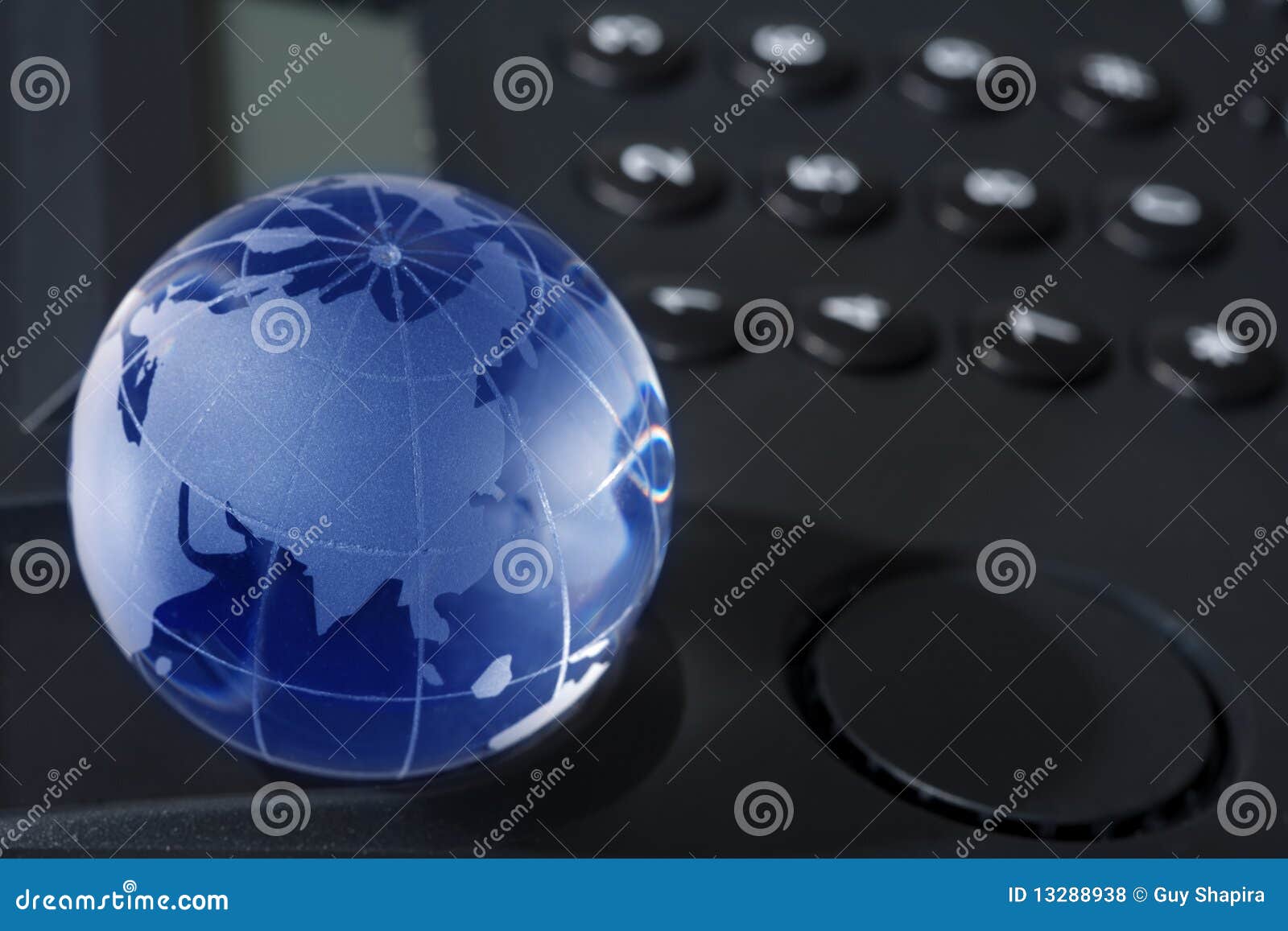 Glass globe with phone stock photo. Image of contact 13288938