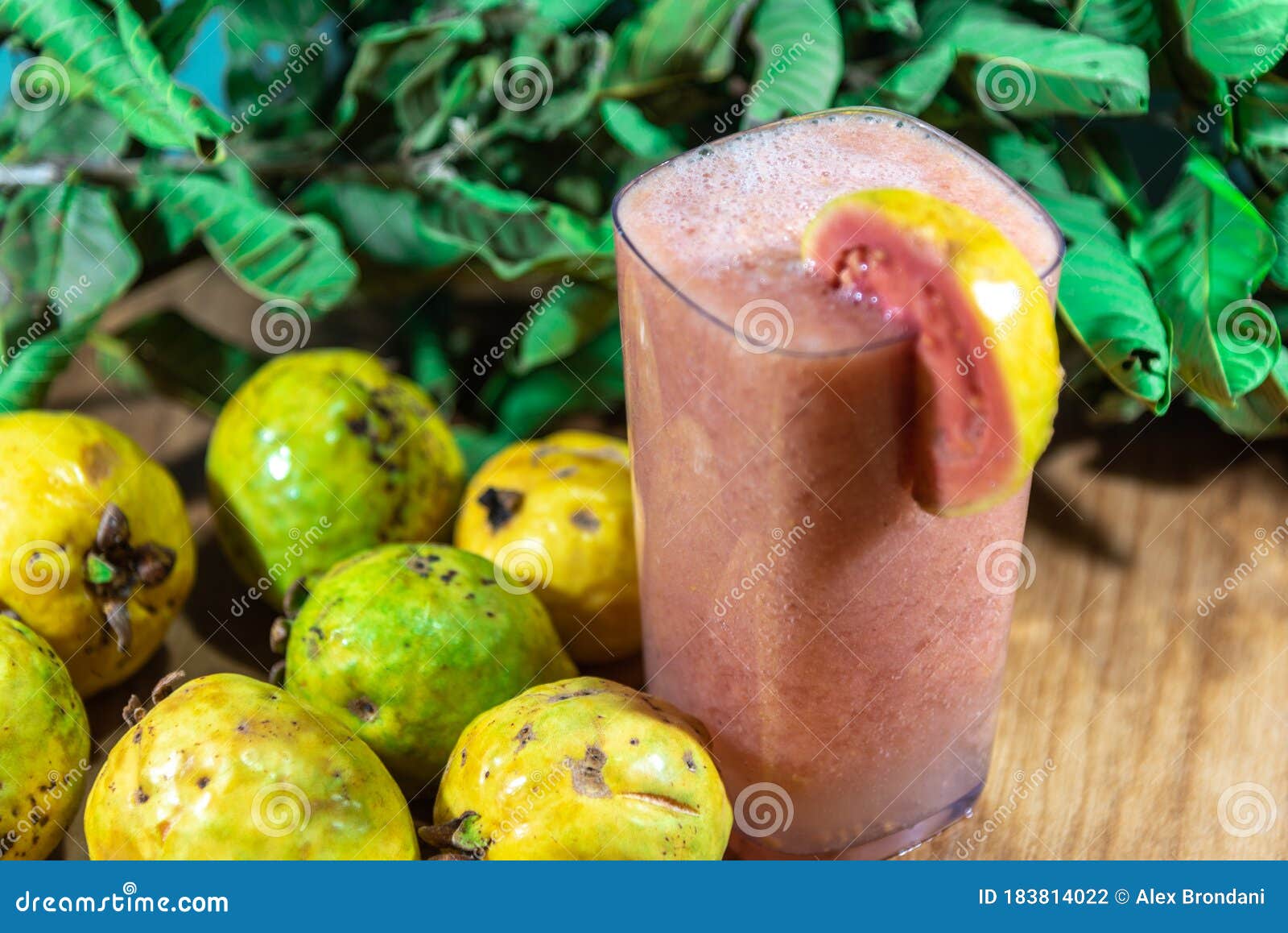 glass of guava juice (psidium guajava) and natural fruits