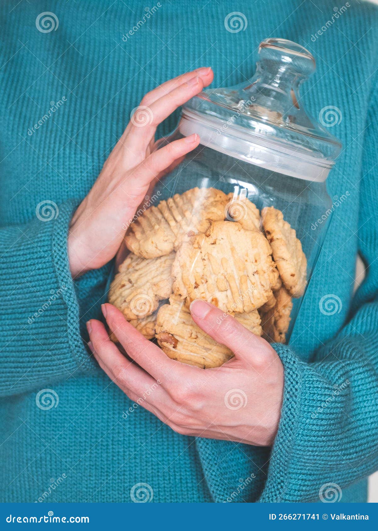 Glass Jar with Homemade Biscuits in Human Hands. Pastry Cookies