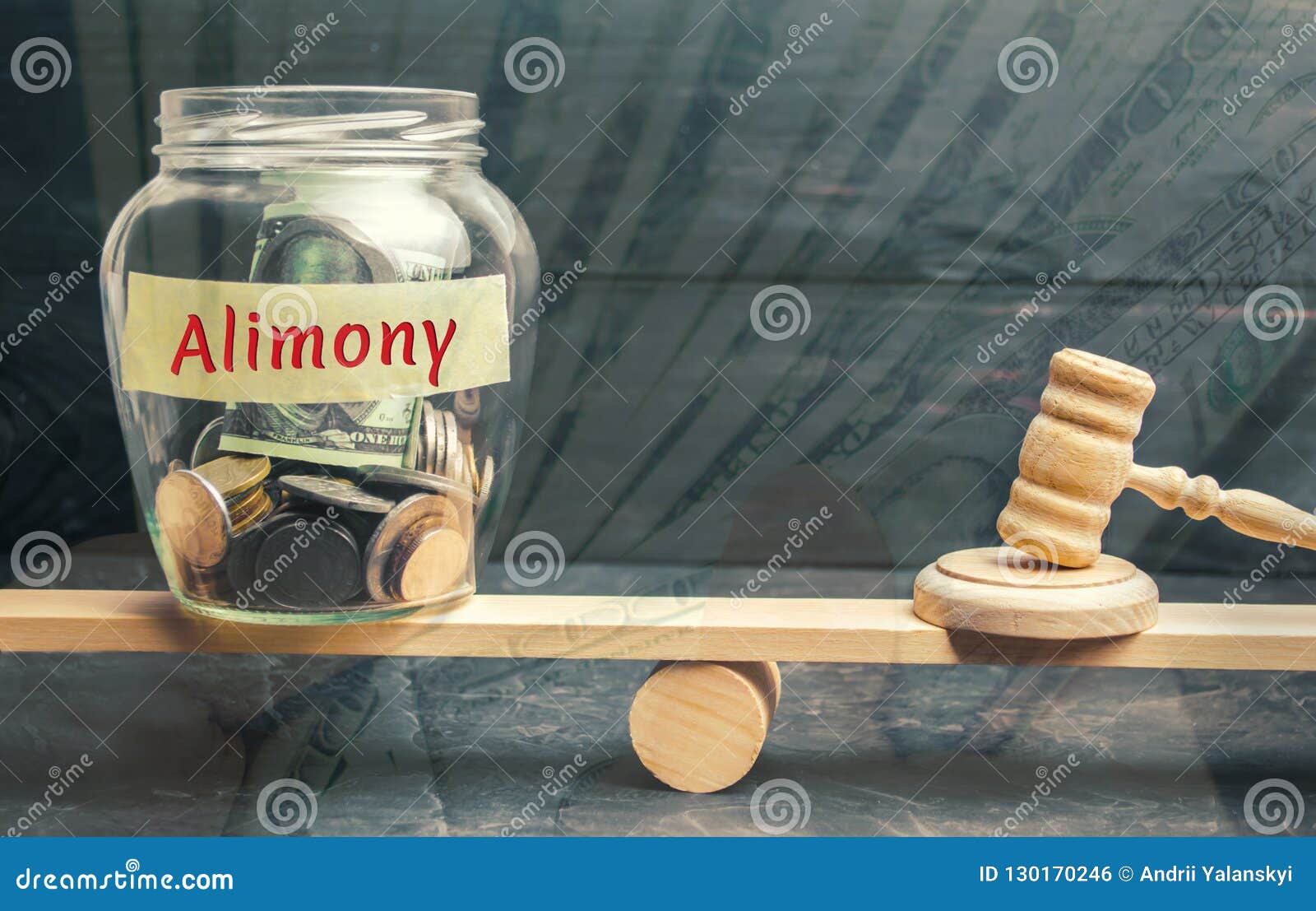 glass jar and the inscription `alimony` and the hammer of the judge are on the scales. payment of alimony of one of the spouses. d