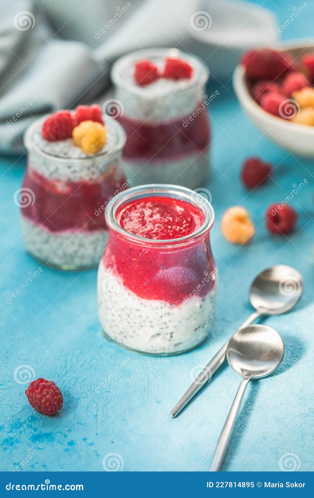 Glass Jars with Chia Pudding with Raspberry and Jam. Bowl of Raspberry