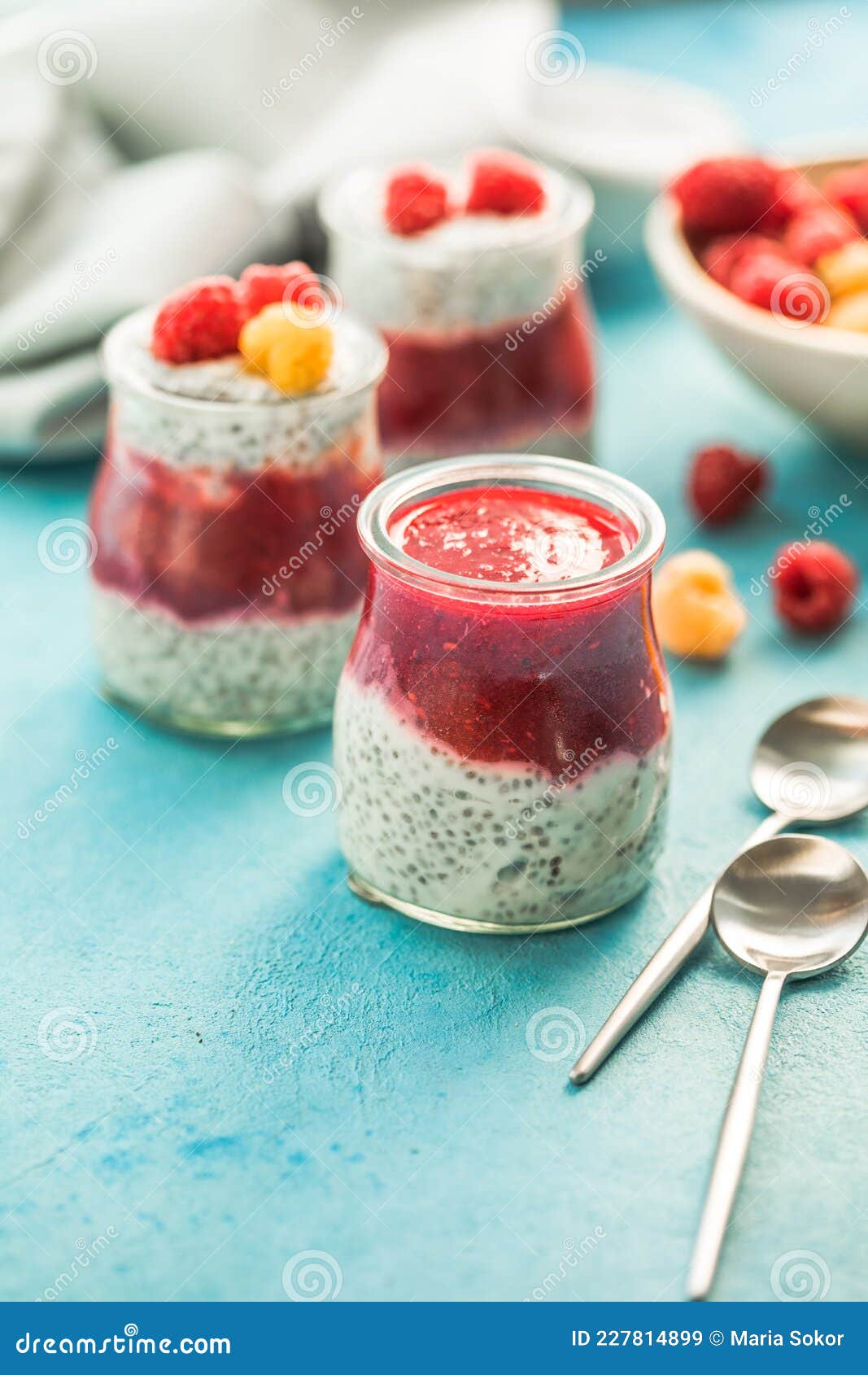 Glass Jars with Chia Pudding with Raspberry and Jam. Bowl of Raspberry