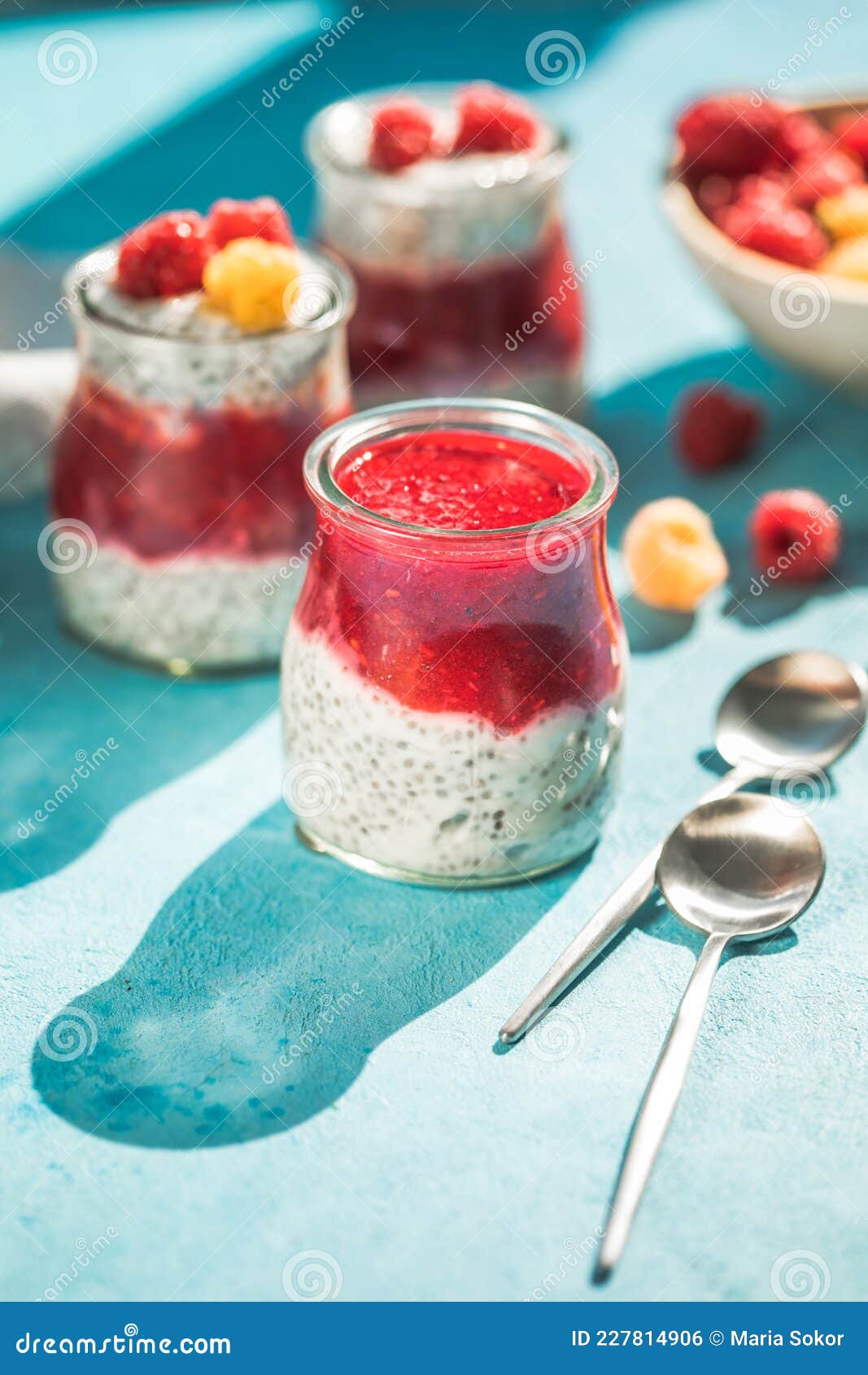 Glass Jars with Chia Pudding with Raspberry and Jam. Bowl of Raspberry