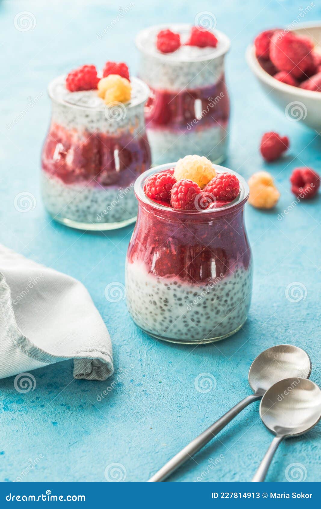 Glass Jars with Chia Pudding with Raspberry and Jam. Bowl of Raspberry