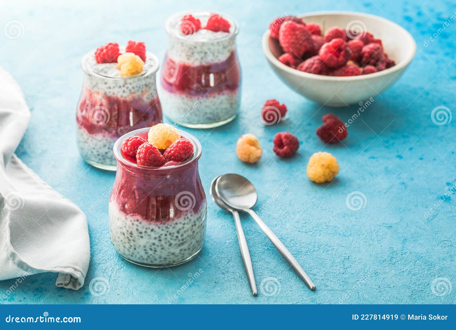 Glass Jars with Chia Pudding with Raspberry and Jam. Bowl of Raspberry