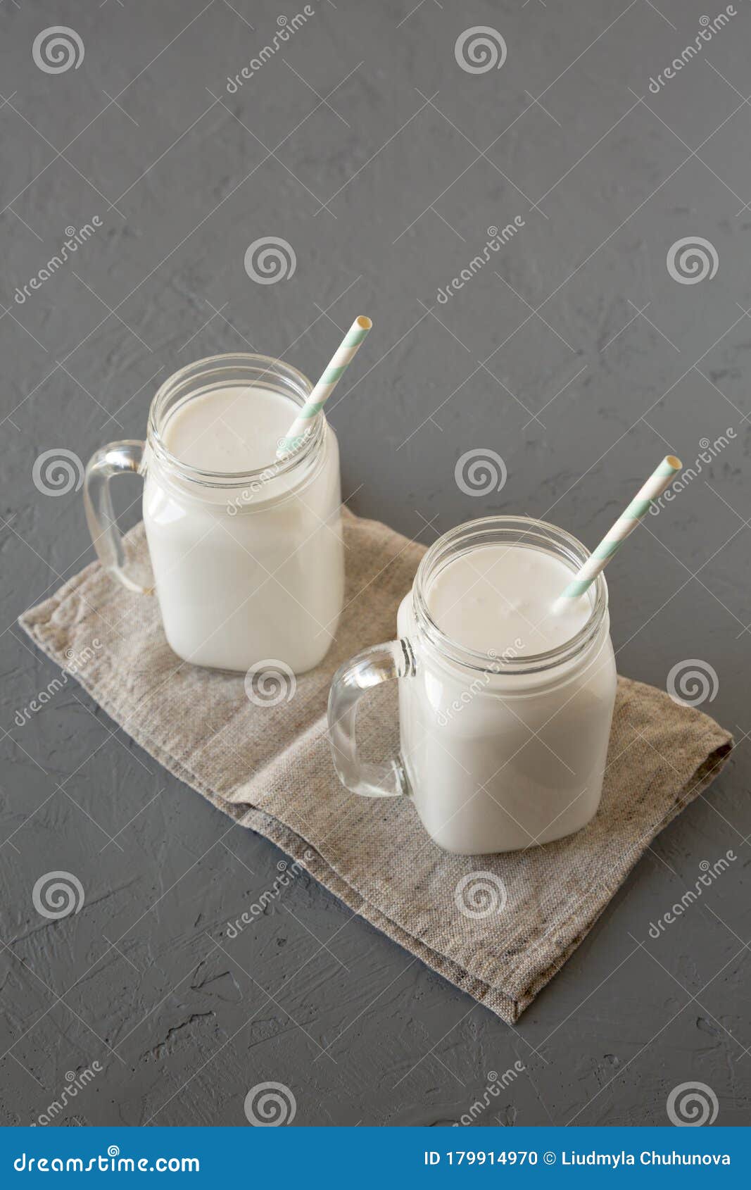Glass Jars Filled with Coconut Milk, High Angle View. Copy Space Stock