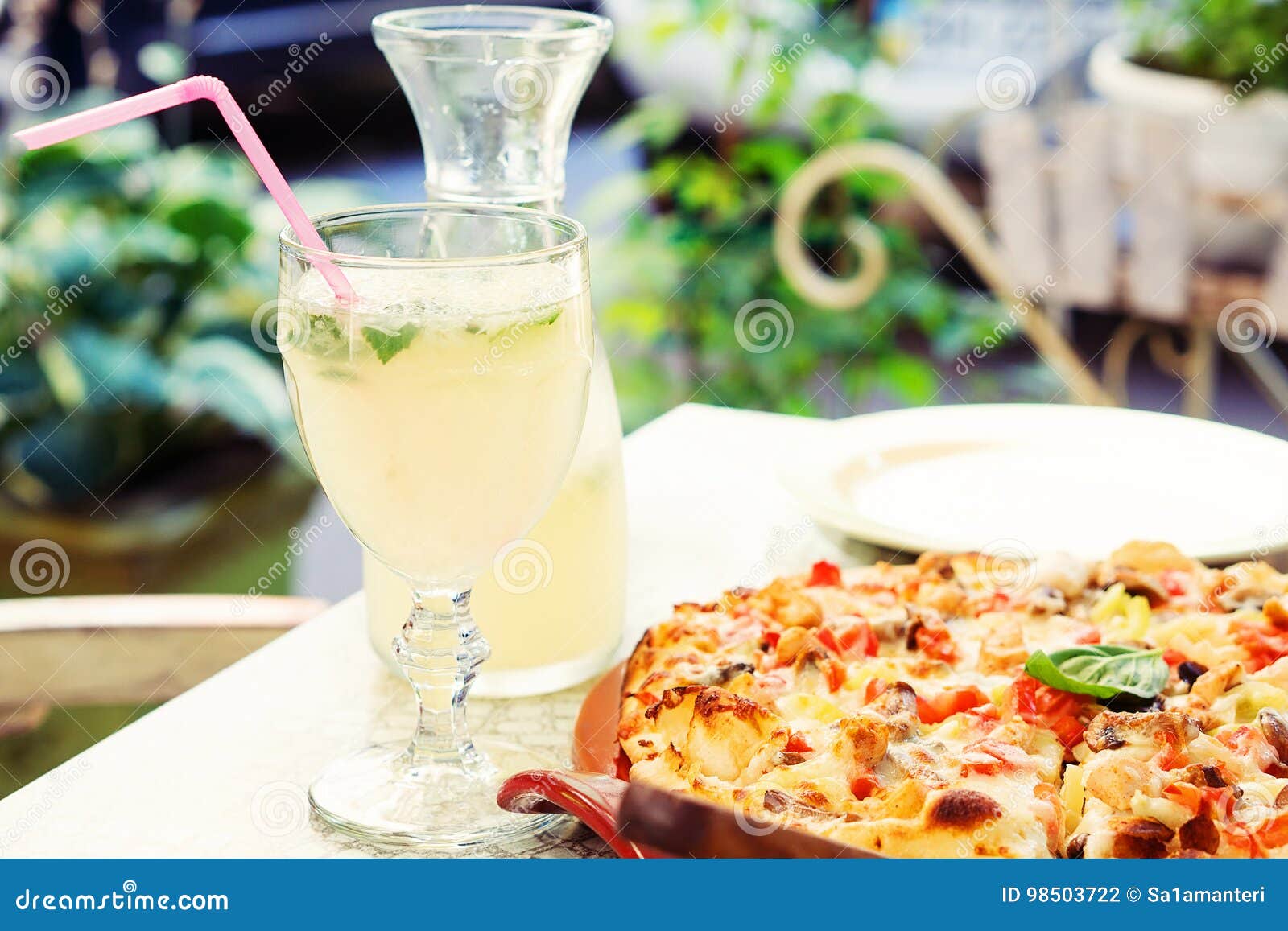 The Glass of Lemonade and Pizza on the Summer Terrace Stock Photo