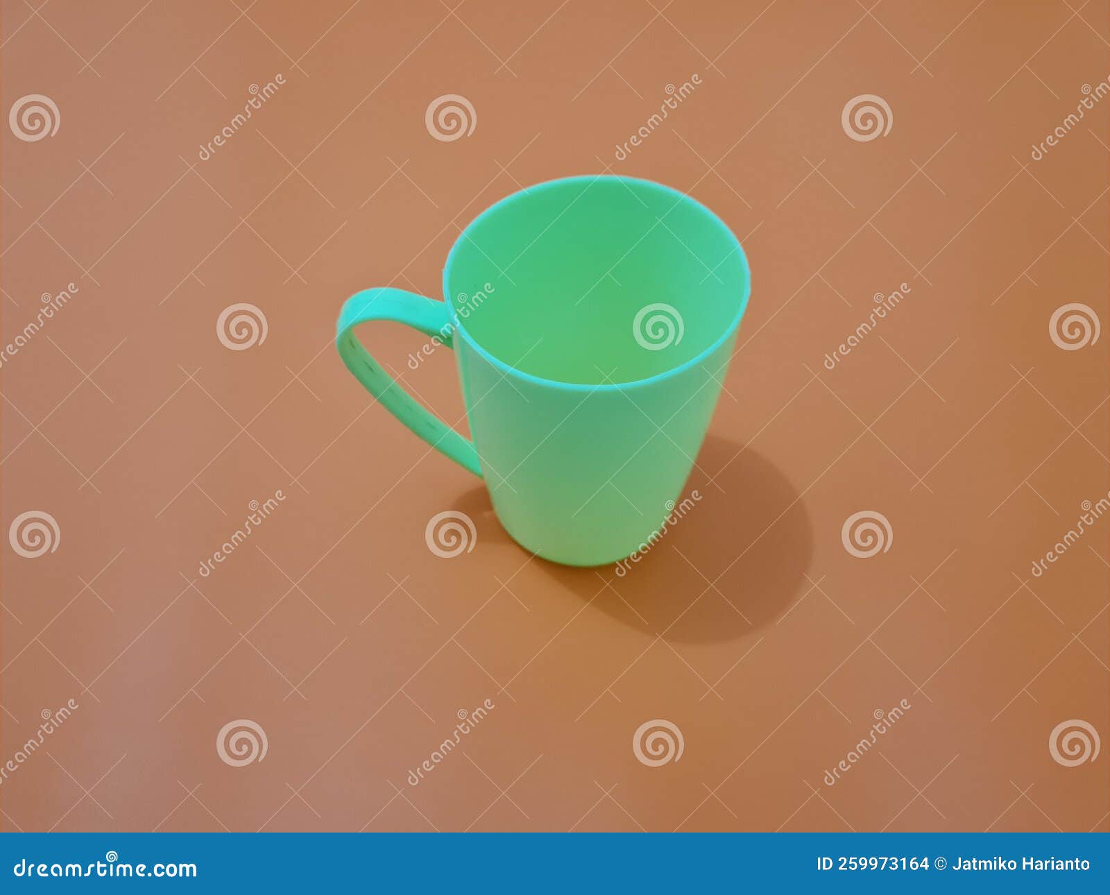 A Glass Made of Plastic with a Green Handle Stock Photo - Image of