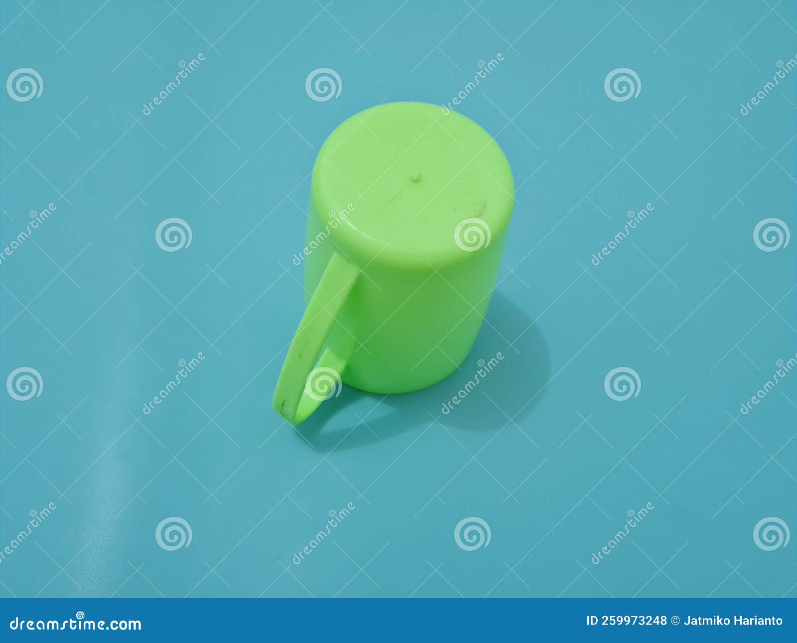A Glass Made of Plastic with a Green Handle Stock Photo - Image of