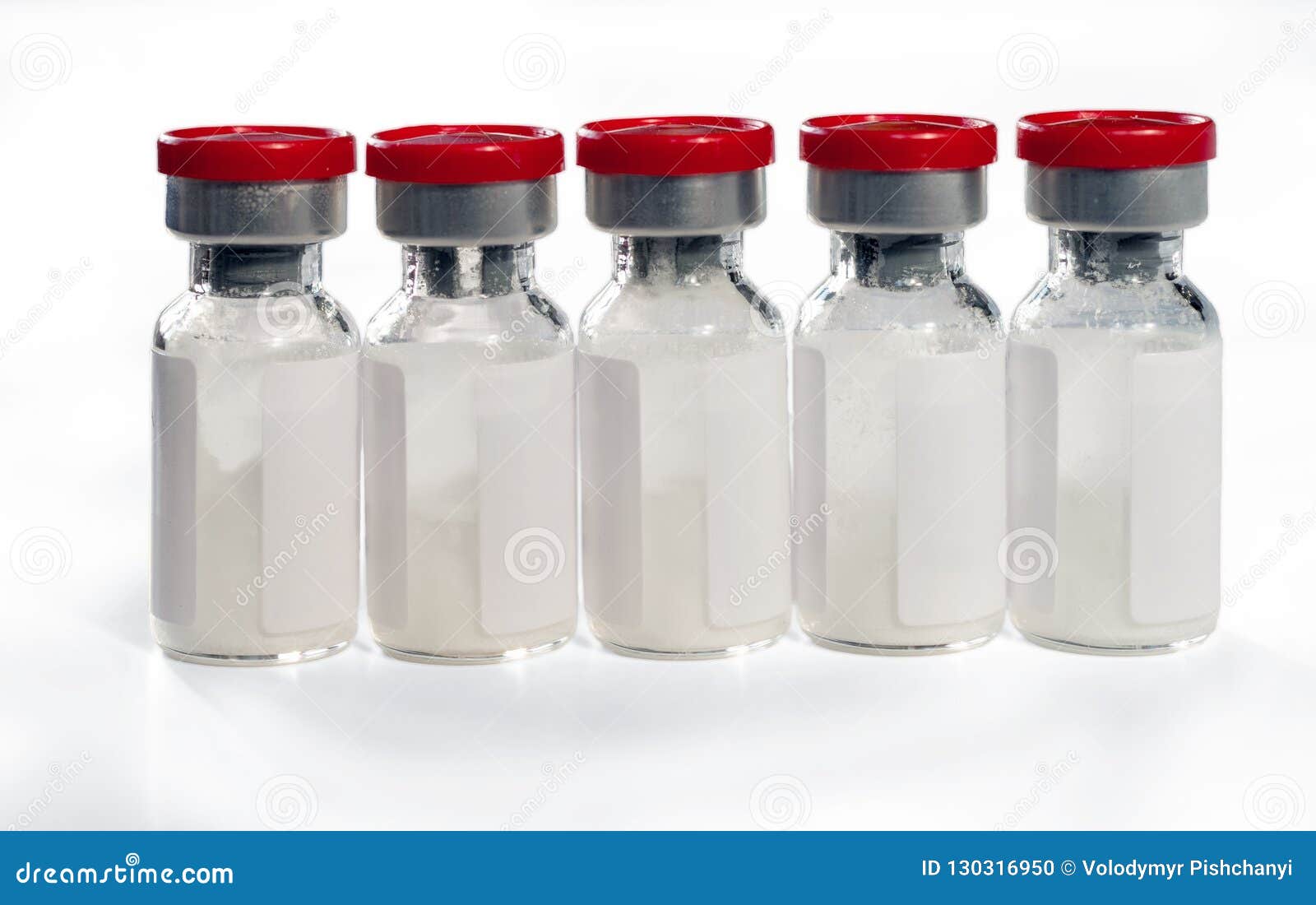 glass medical vials of biotech drugs with red caps.  on white background
