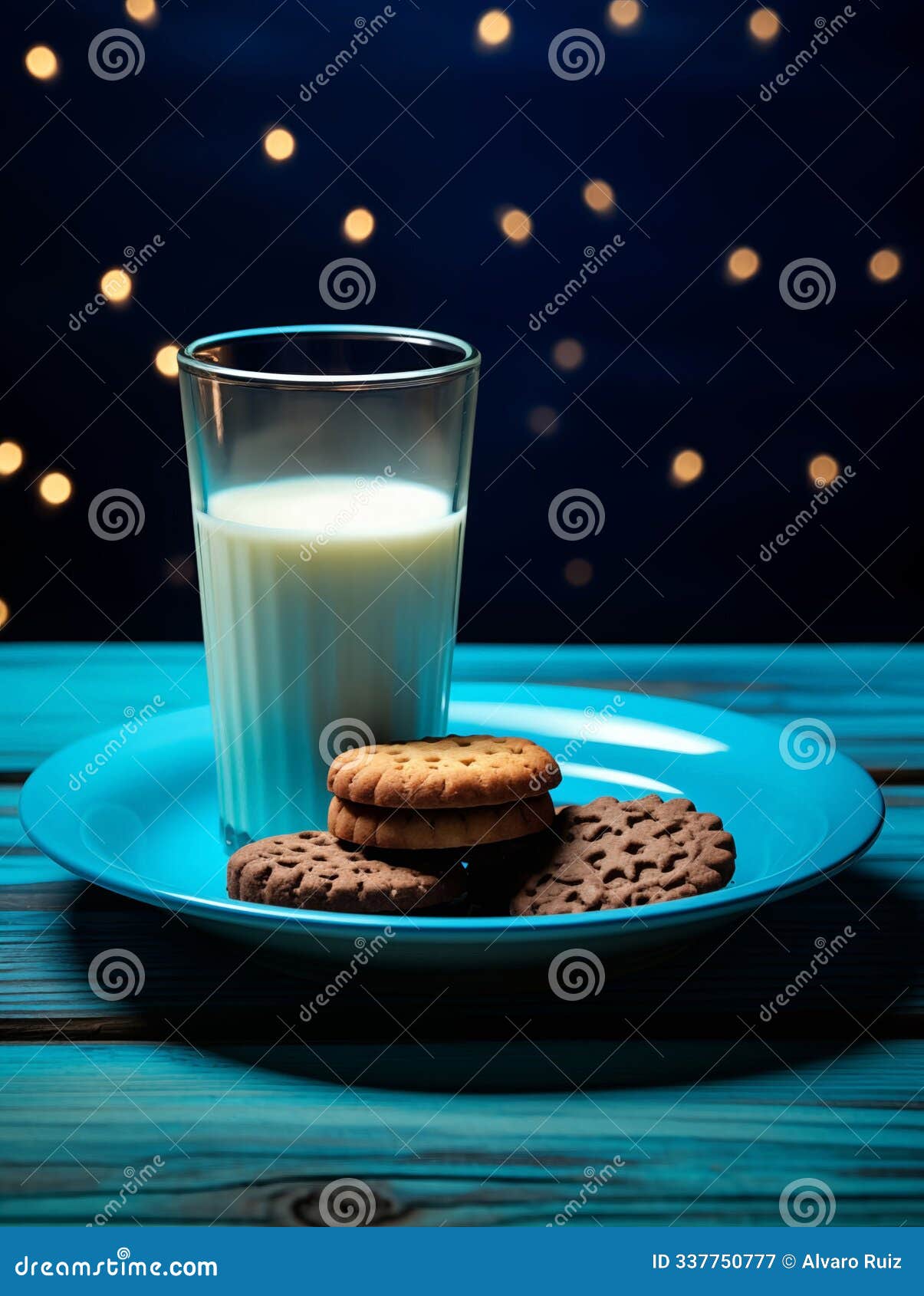glass of milk with assorted cookies on blue plate, evening setting