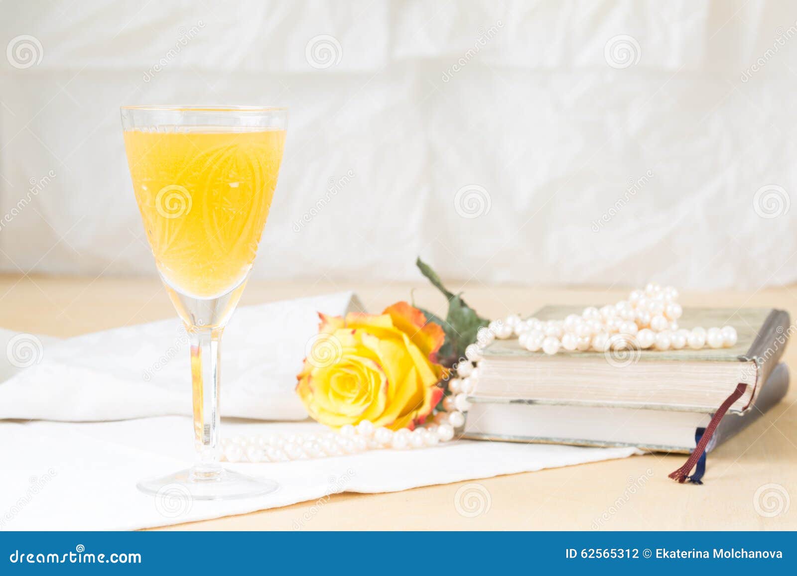 https://thumbs.dreamstime.com/z/glass-mimosa-cocktail-vintage-books-pearls-lightweight-background-style-horizontal-62565312.jpg