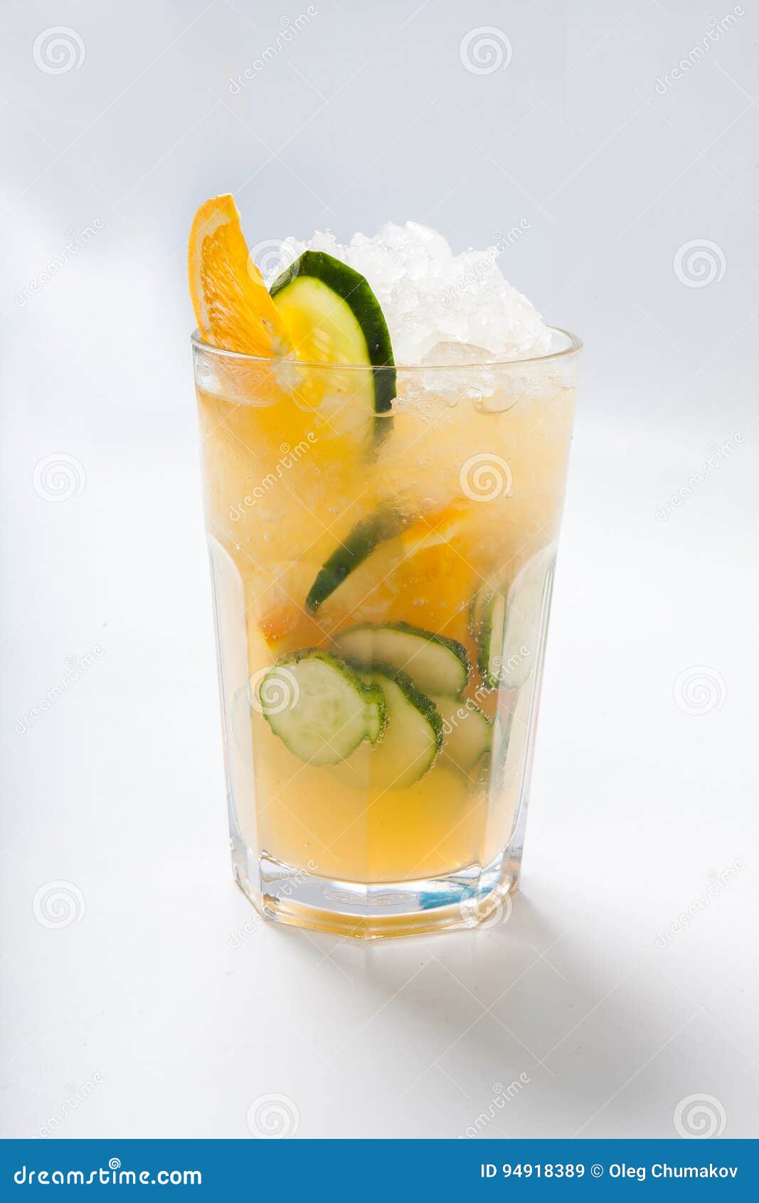 glass with orange cucumber refreshing drink, rustic style, selective focus