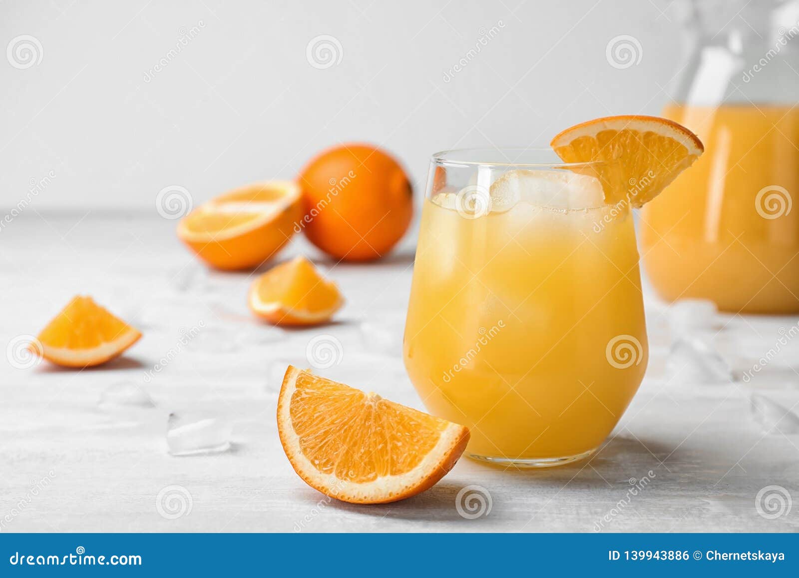 Juice In Glass Jar And Orange On Kitchen Table. Stock Photo