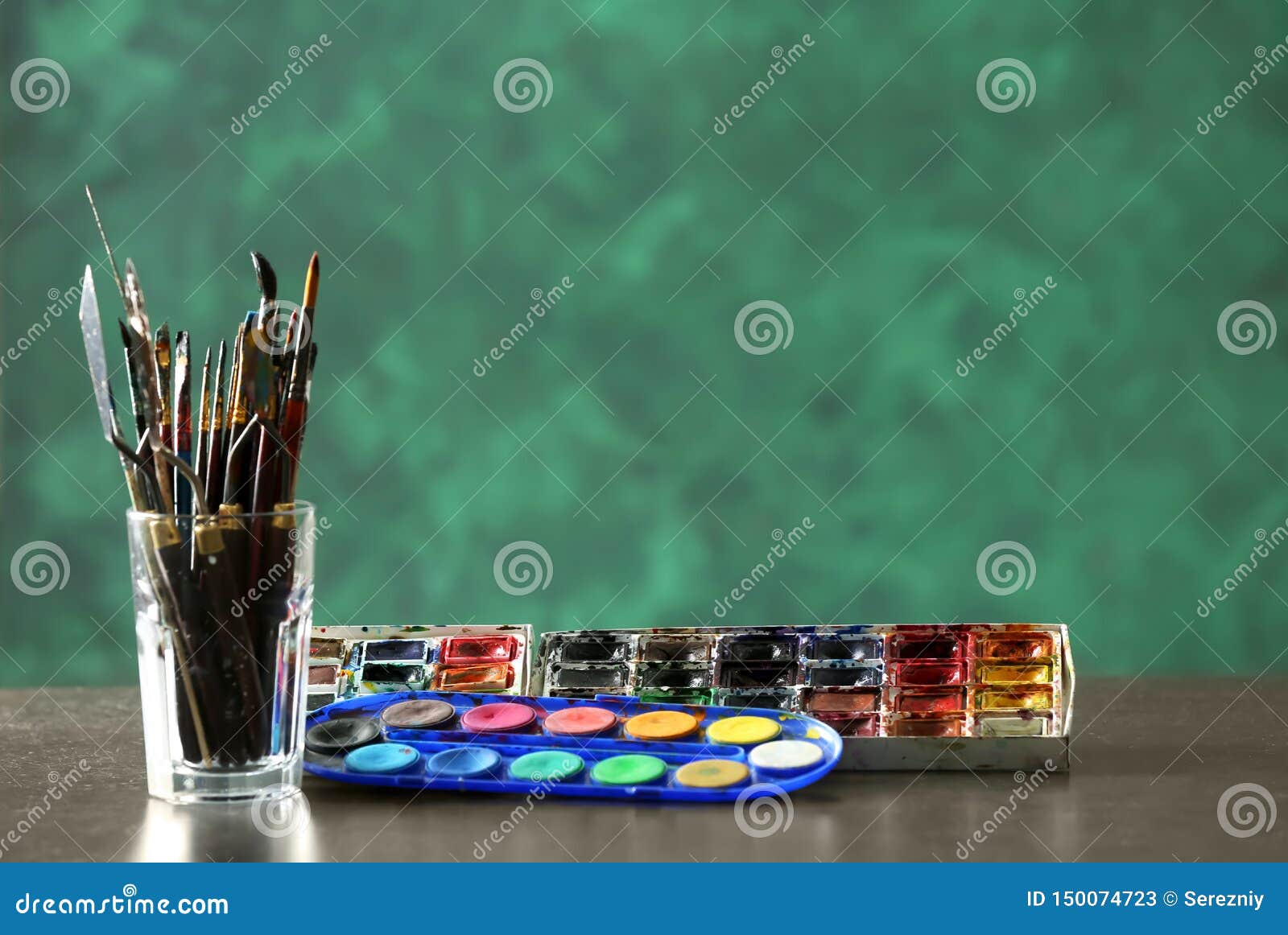 Glass With Paint Tools And Watercolors On Table Stock Image Image Of