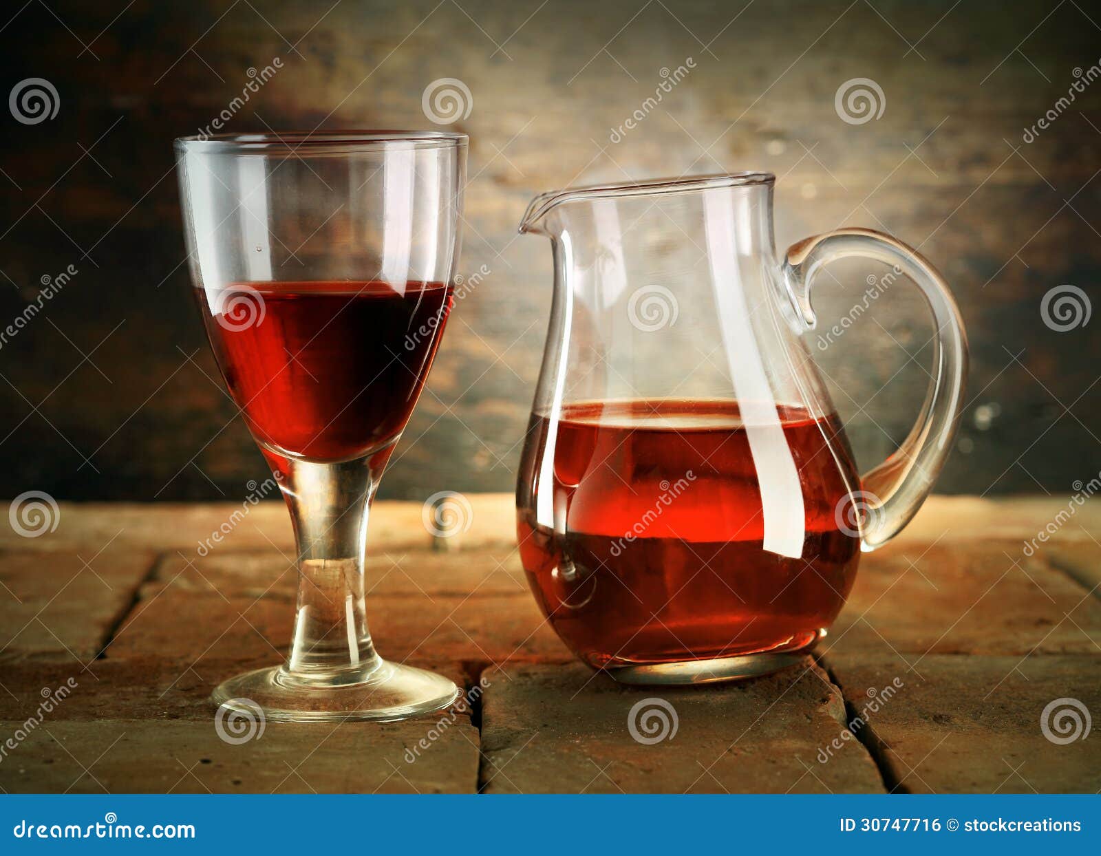A Glass of Red Wine with a Jug of Wine Stock Photo Image of drinks