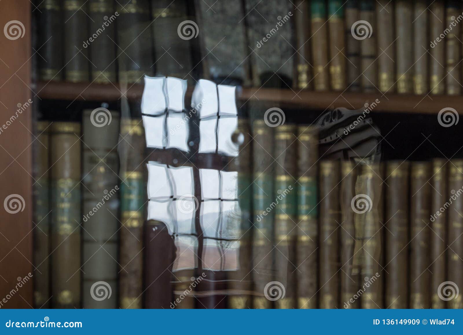 glass reflection of old bookcase in an ancient library
