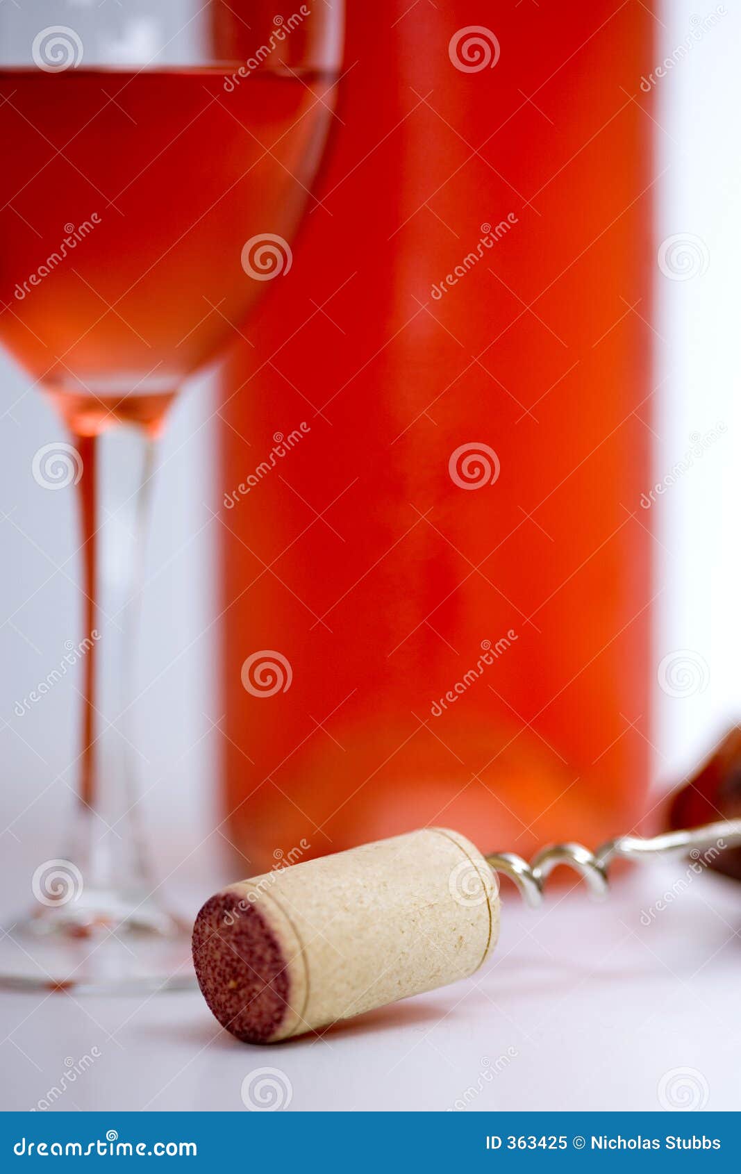 Glass of Rose Wine with Bottle, Corkscrew and White Background Stock