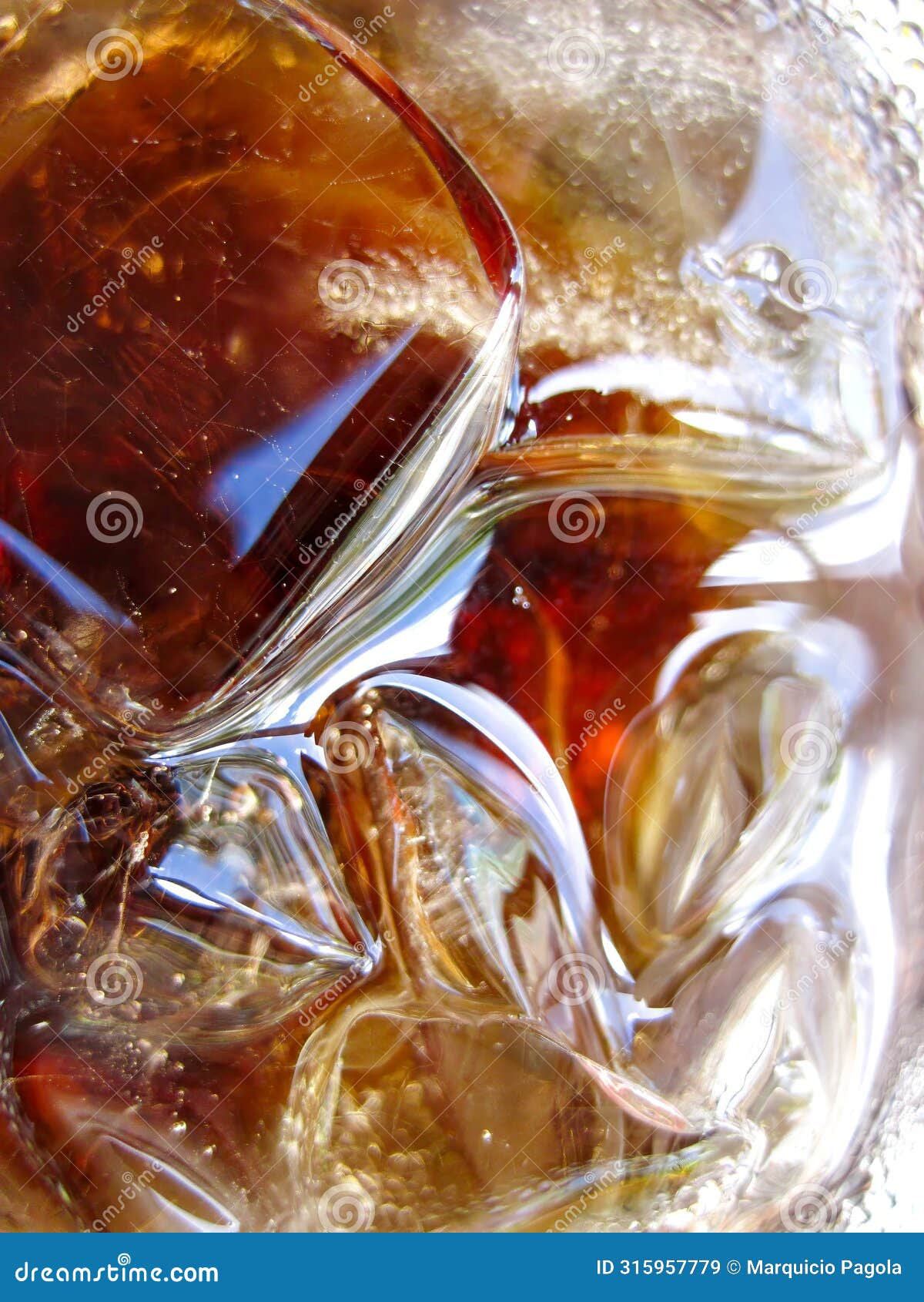 a glass of soda with ice cubes in it