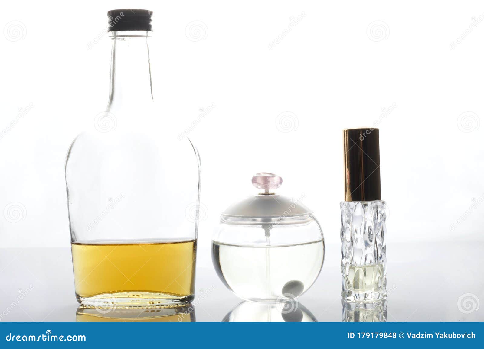 Glass Transparent Bottle with Strong Alcohol. Nearby are Bottles of