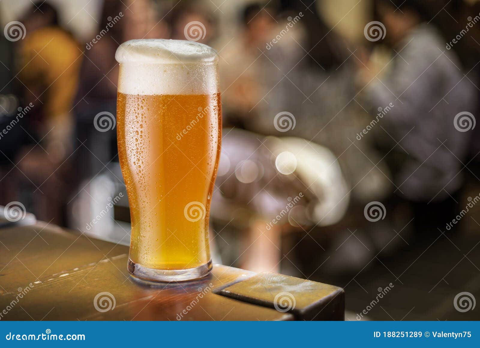 glass of unfiltered beer stands on a table in a pub