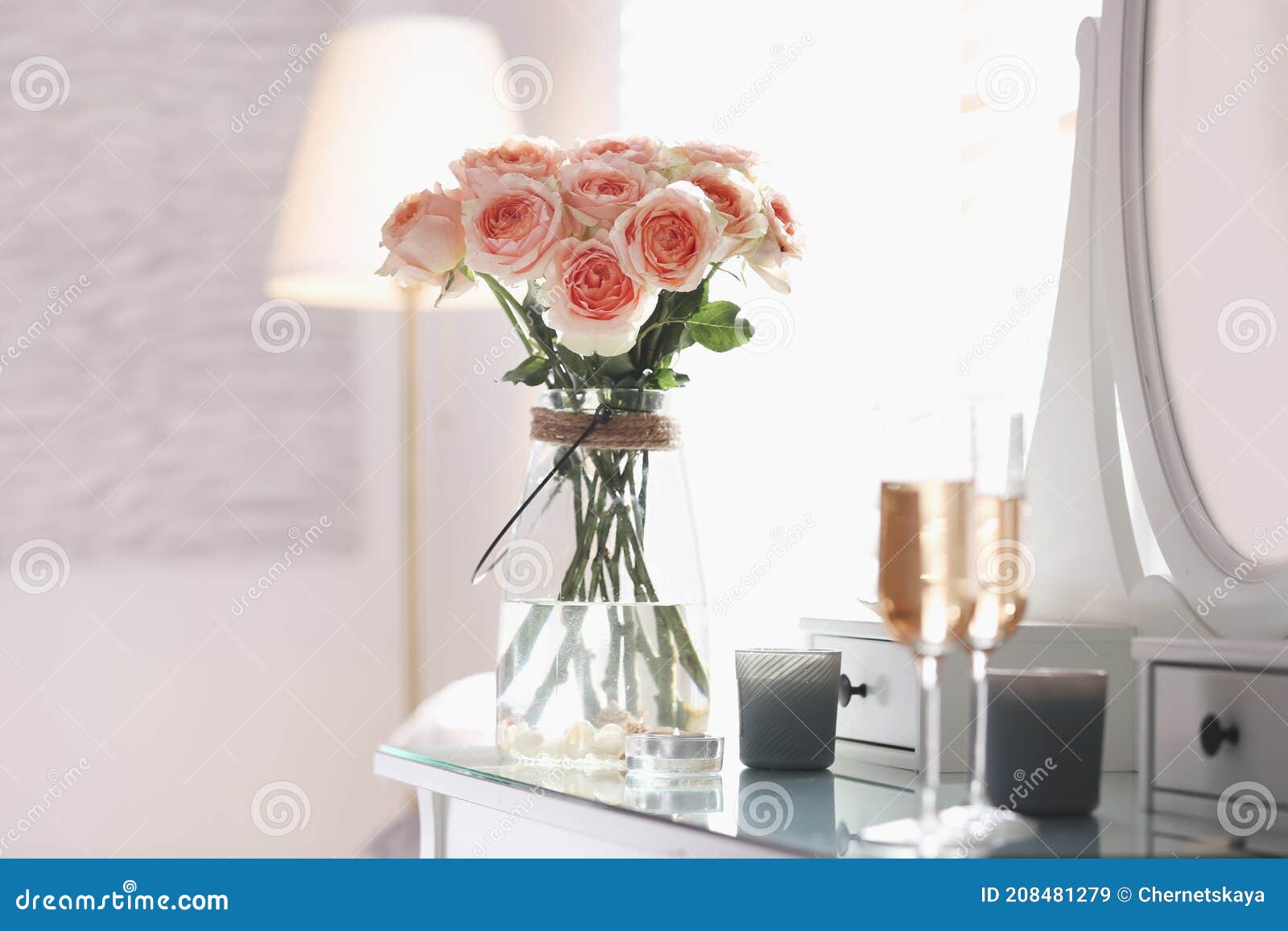 Glass Vase with Beautiful Flowers on Dressing Table in Modern Room
