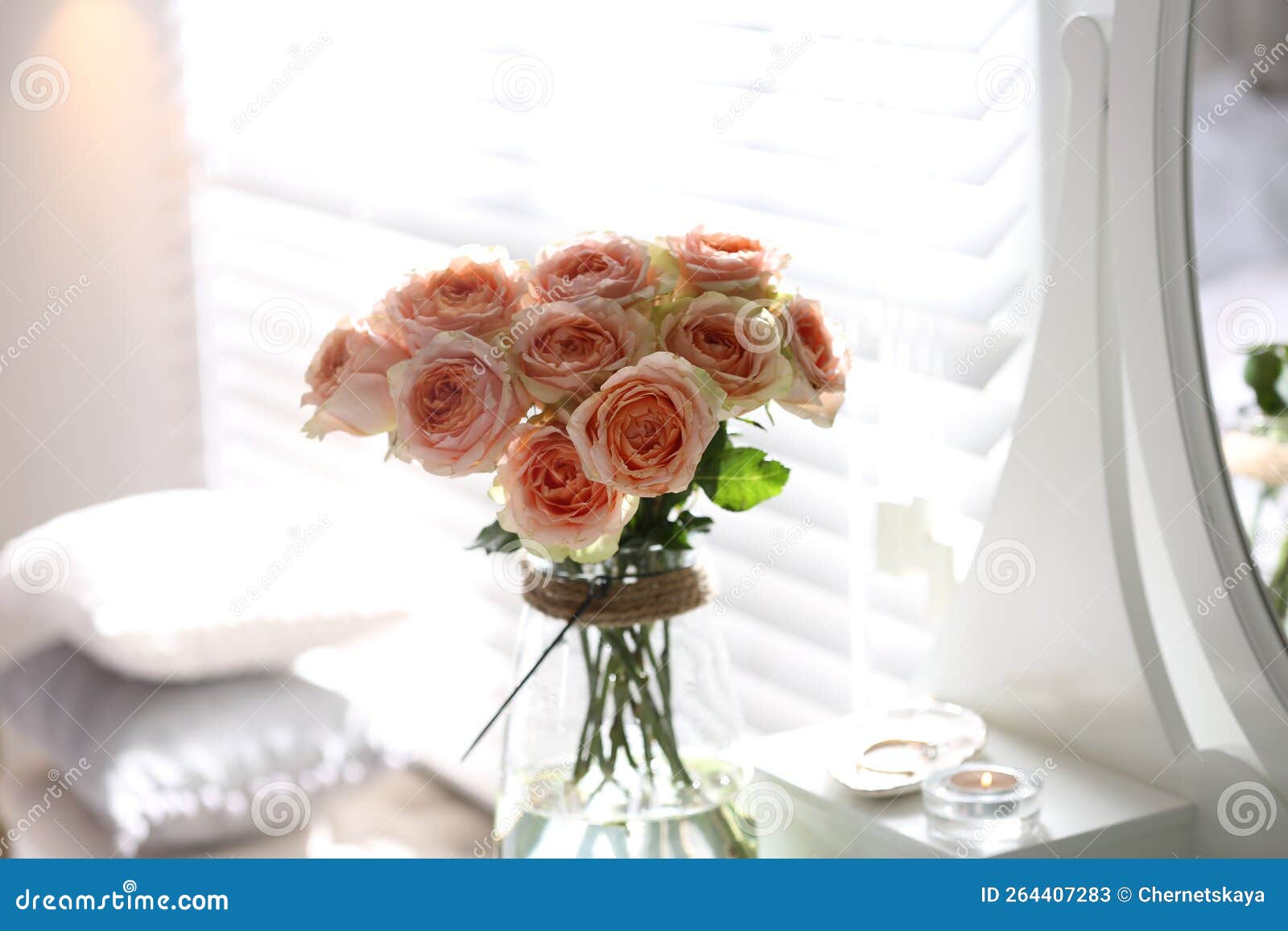 Glass Vase with Beautiful Flowers on Dressing Table in Modern Room