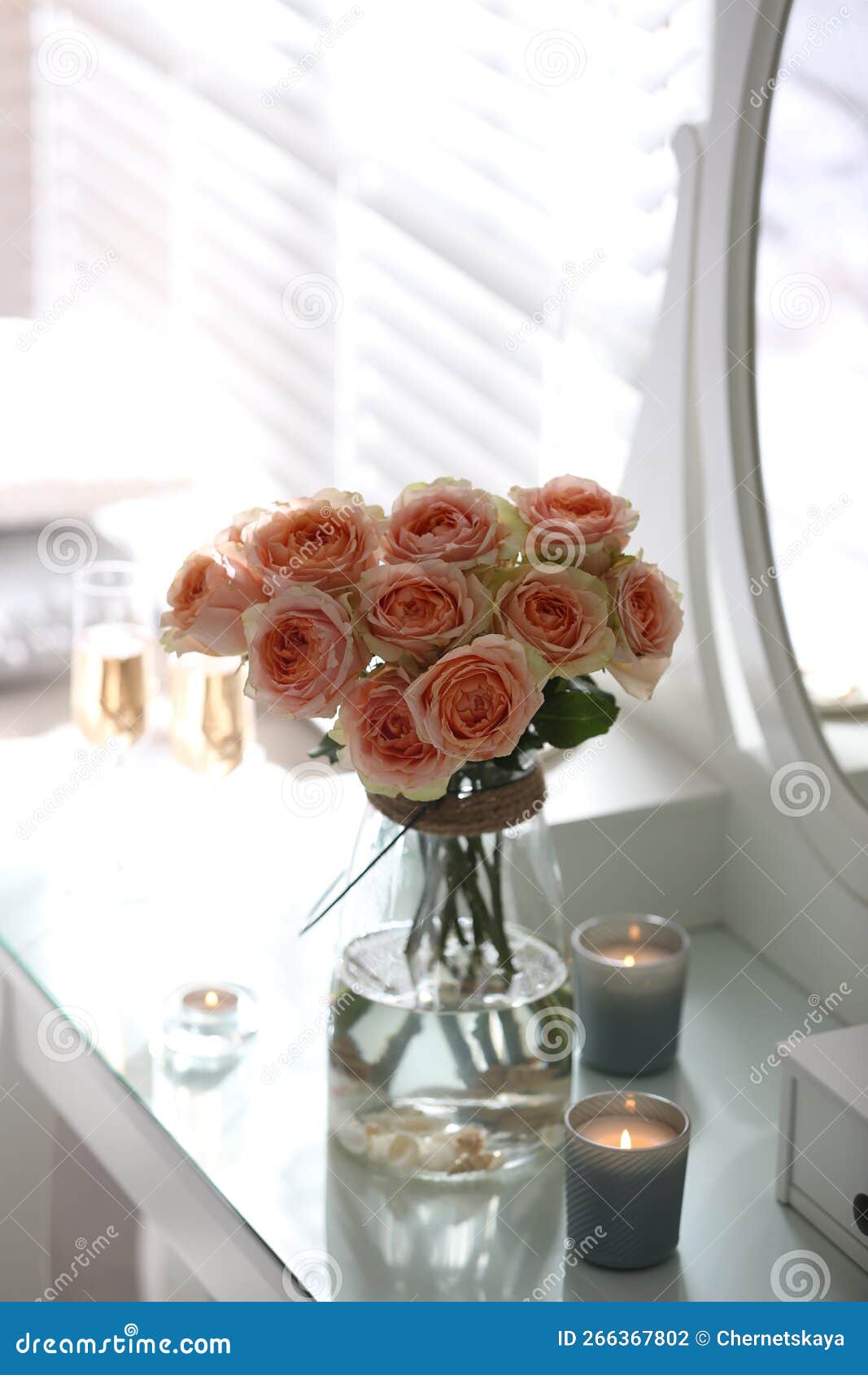 Glass Vase with Beautiful Flowers on Dressing Table in Modern Room