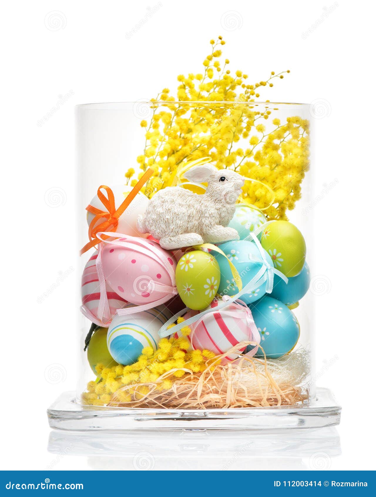 Glass Vase with Easter Decorations. Bunny Rabbit, Yellow Flowers and