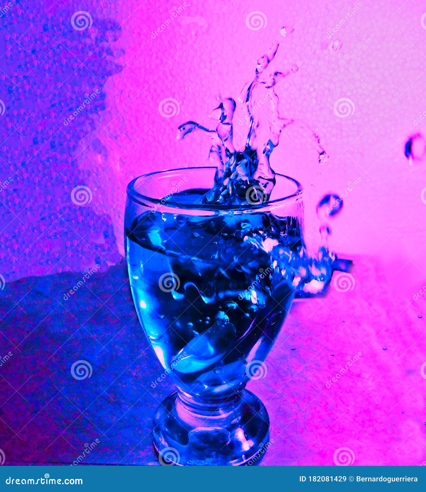 glass of water splashing drops of liquid.