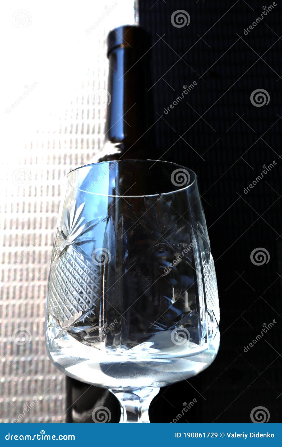 glass goblet on a bottle background