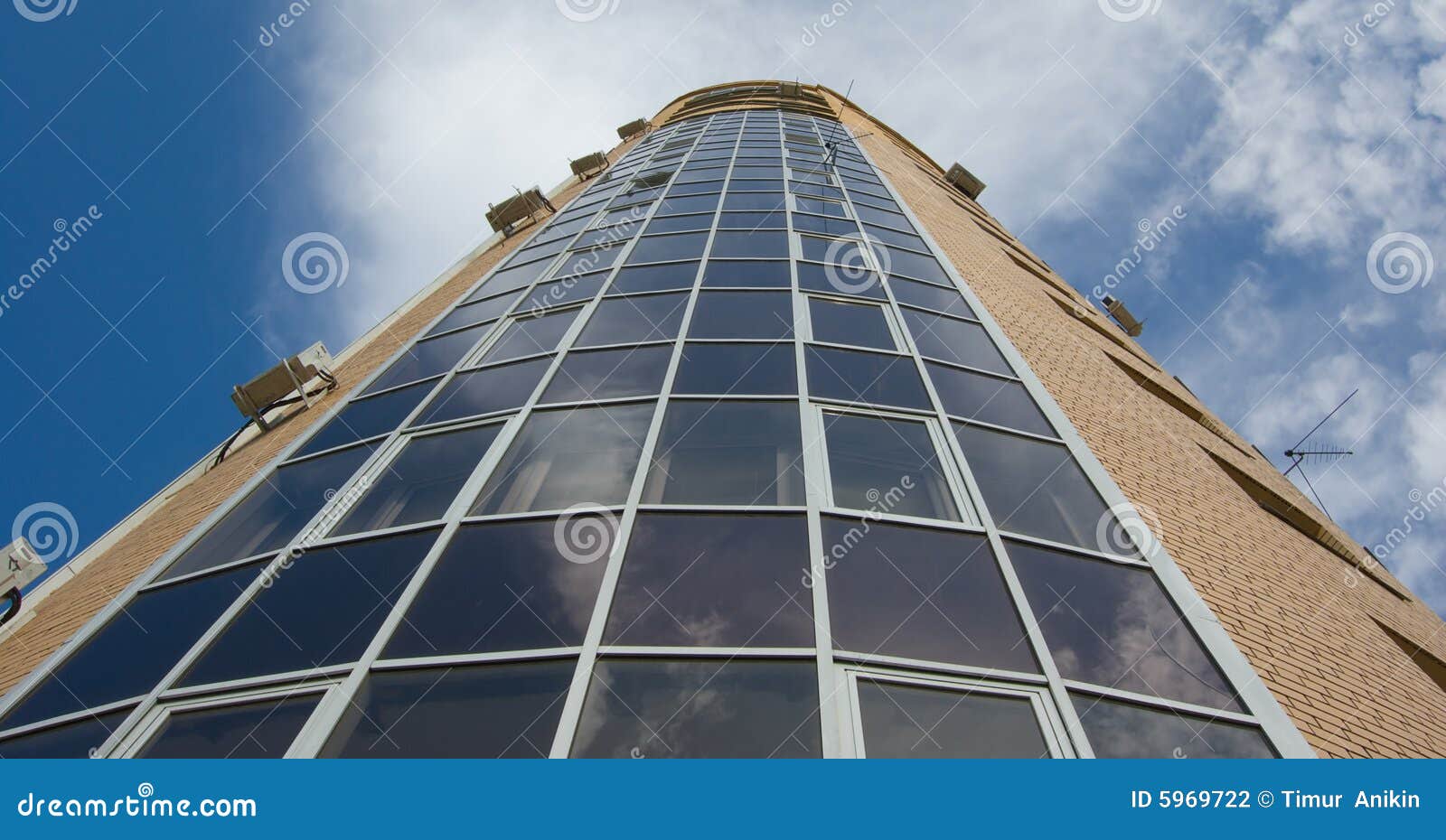 glass and yellow brick multistory tower house