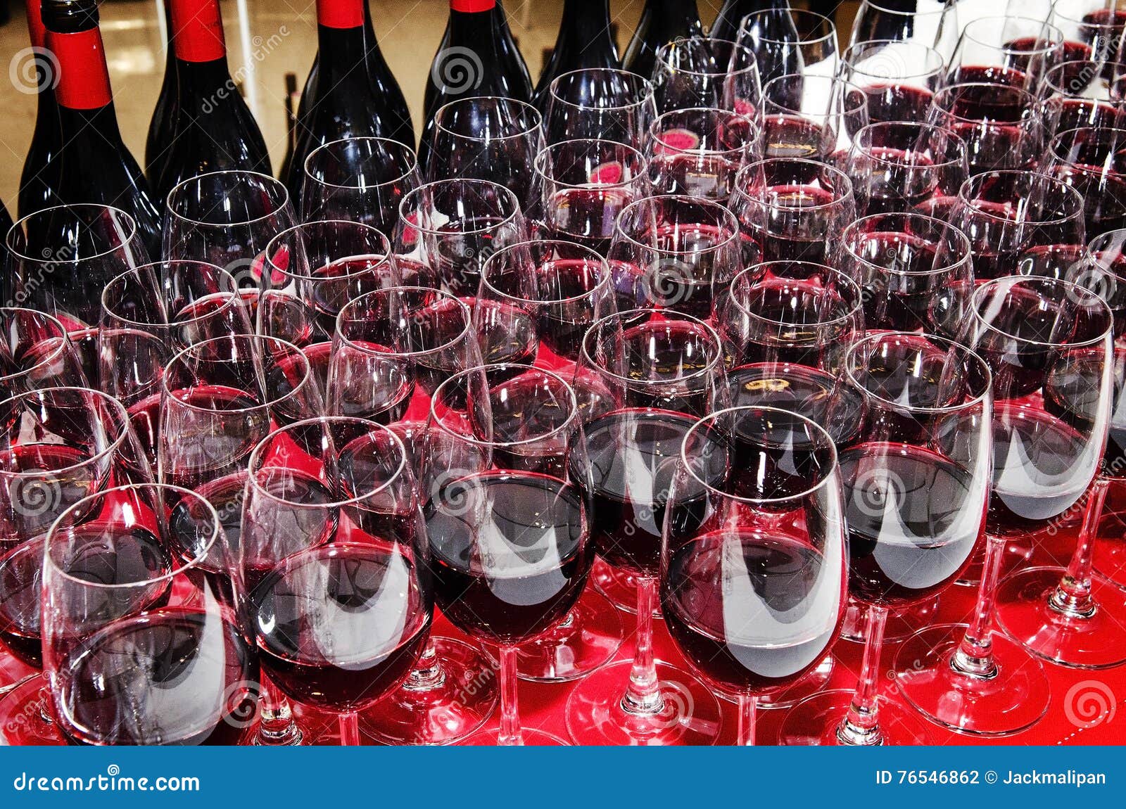 Glasses and Bottles of Red Wine on Cocktail Party Table Stock Photo
