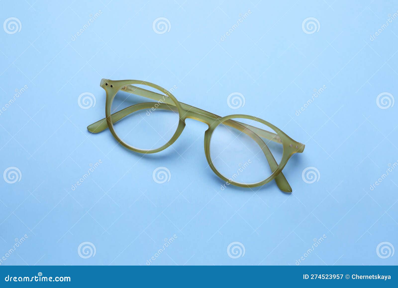 Glasses with Corrective Lenses on Light Blue Background, Top View Stock
