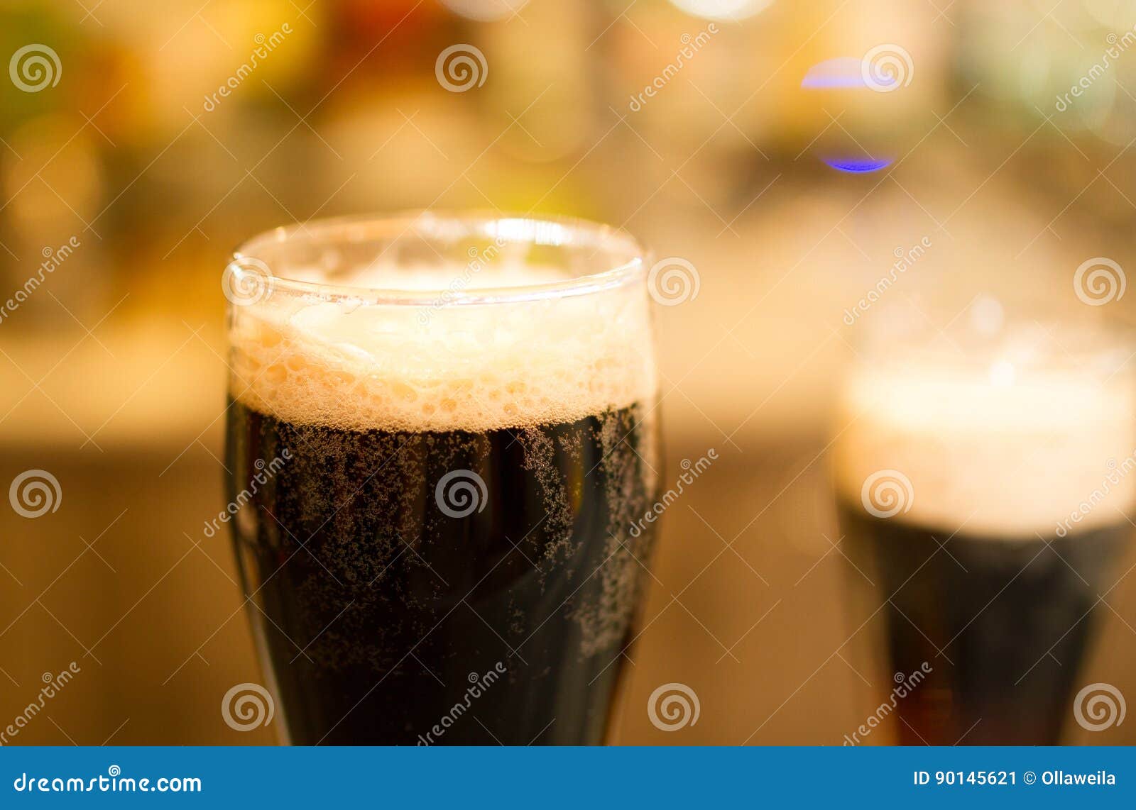 Glasses of dark beer stock image. Image of drink, white 90145621