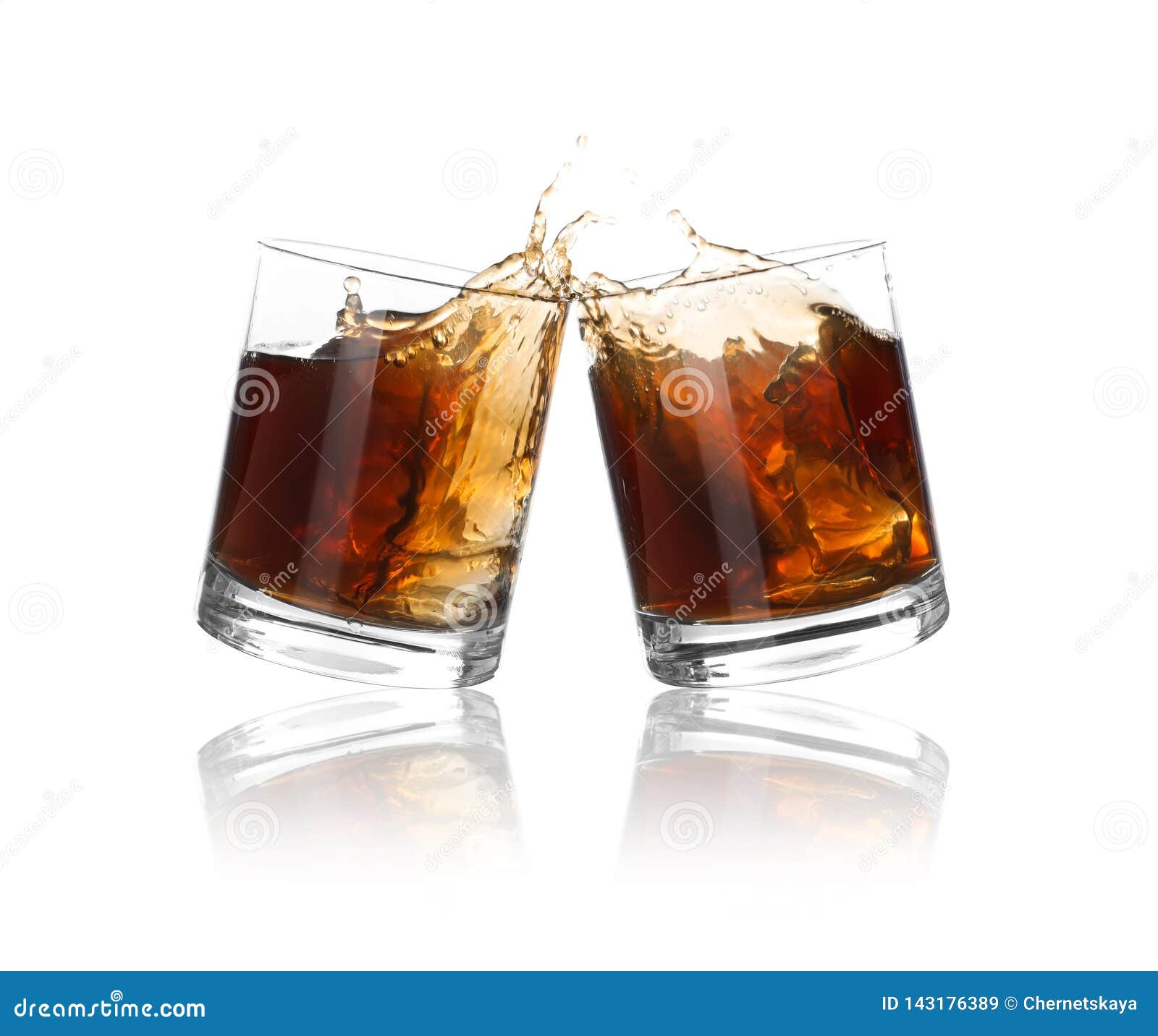 Glasses of Expensive Whiskey Clinking Together and Splashing Stock