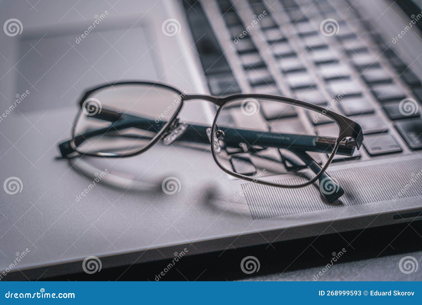 Glasses and a Laptop on a Black Table, Backlight. Closeup Stock Image