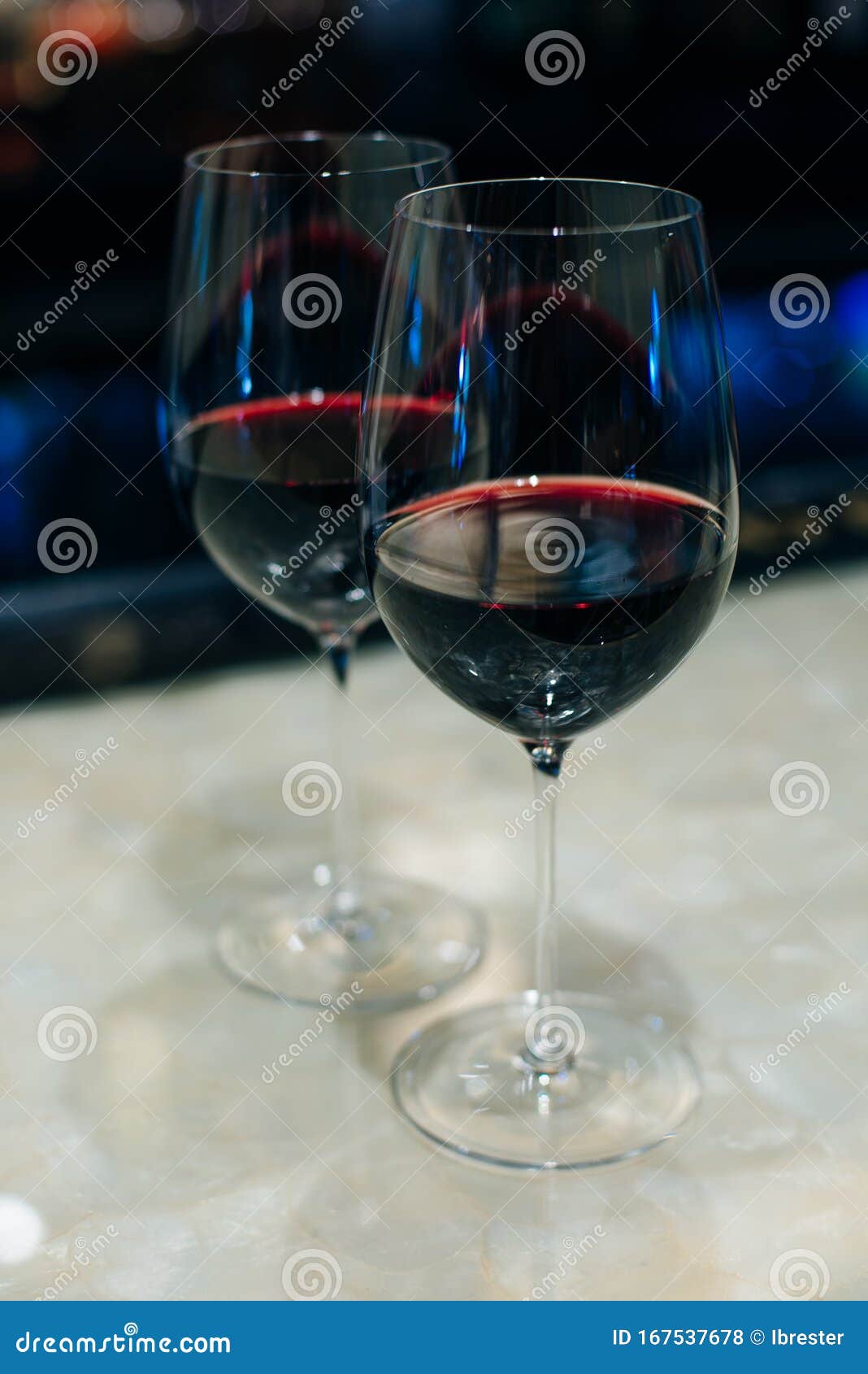 glasses with red wine on bar counter in restaurante