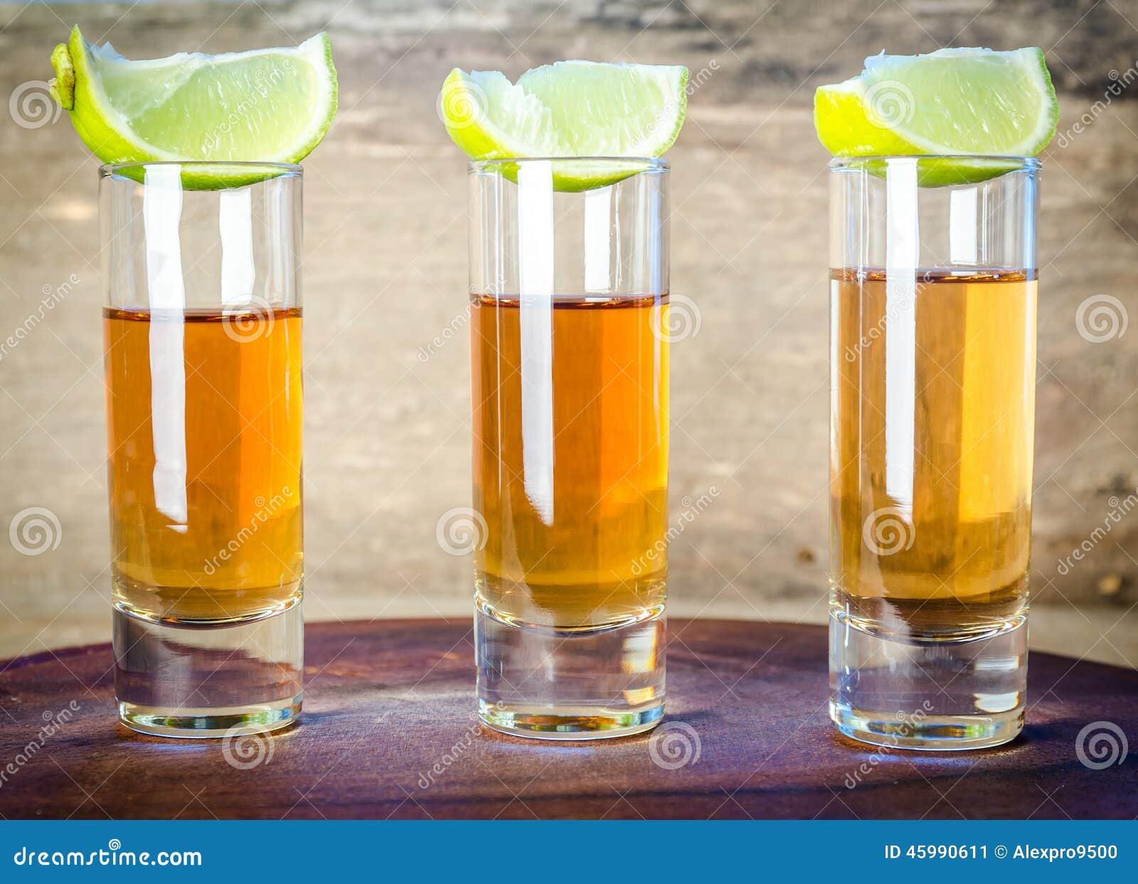 glasses of tequila on the wooden board