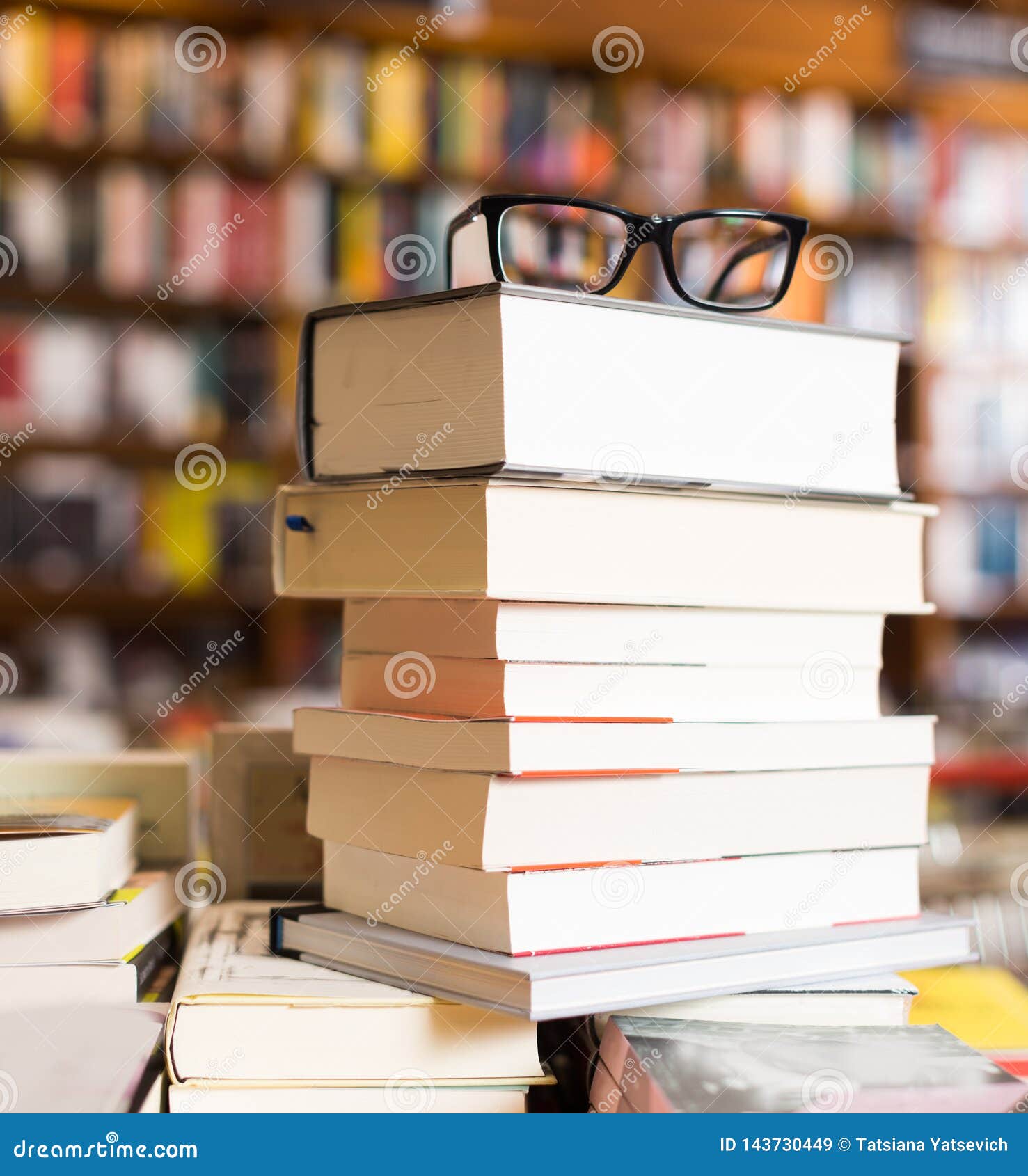 Glasses On Top Of Stack Of Books Lying On Table In Bookstore Stock 