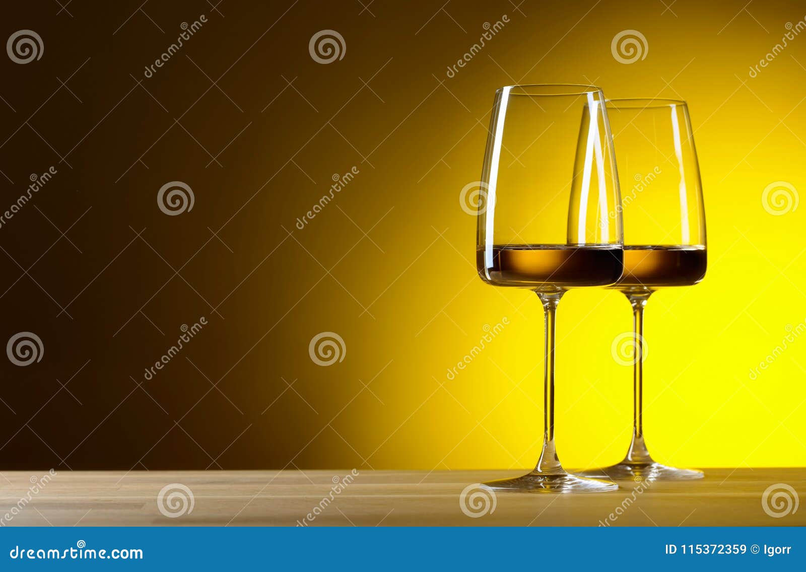 Glasses of White Wine on a Yellow Background. Stock Image Image of